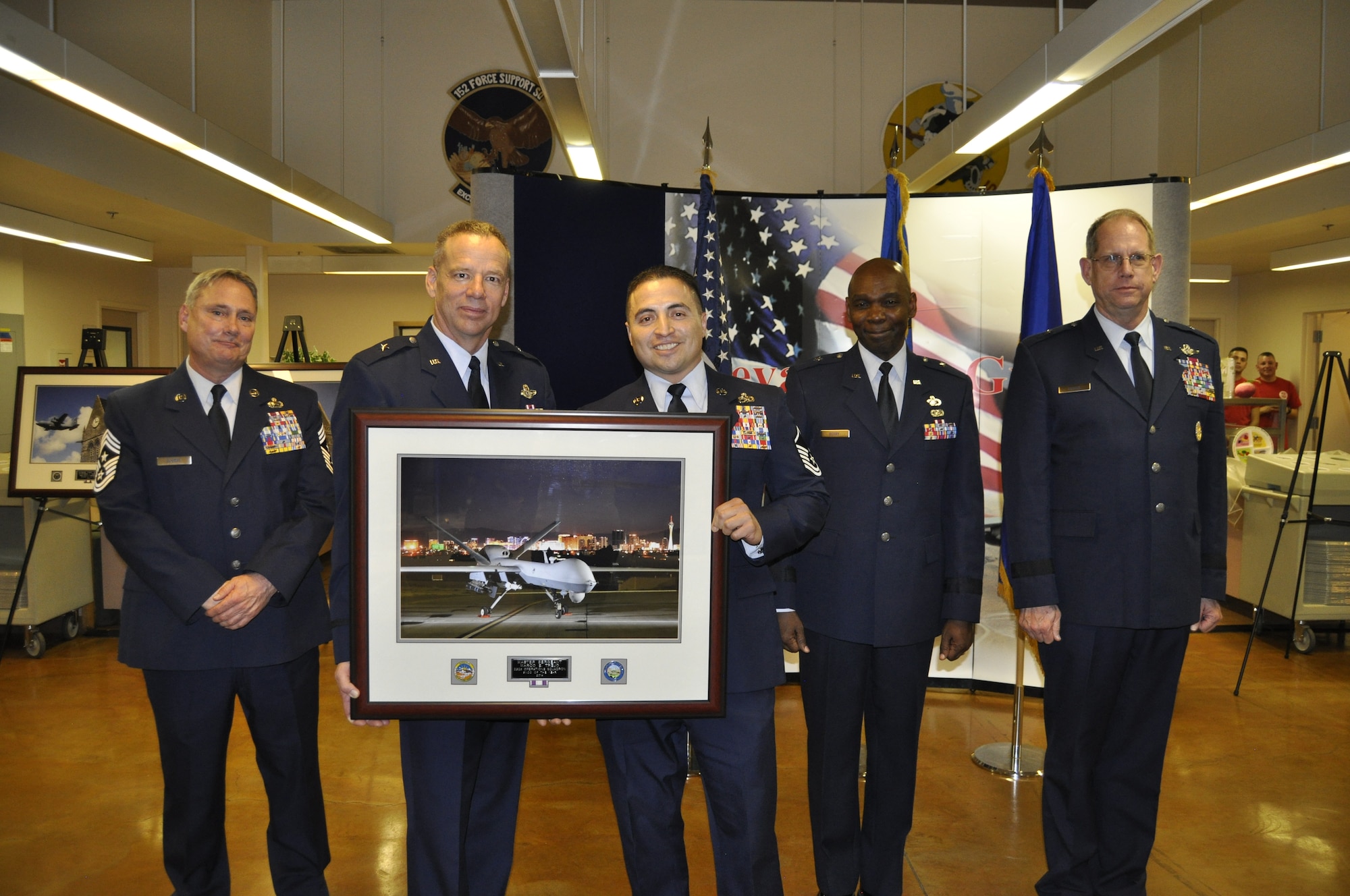 Master Sgt. Marco Trejo accepts his award for being named the Senior Non-Commissioned Officer of the Year from Chief of Staff, Nevada Air National Guard, Brig. Gen. David Snyder at the 2014 Outstanding Airmen of the Year Awards Banquet on Saturday. Left to right, Senior Enlisted Leader, Chief Master Sgt. Rick Scurry; Snyder; Trejo; Assistant Adjutant General, Brig. Gen. Ondra Berry; and the Adjutant General, Brig. Gen. William Burks.