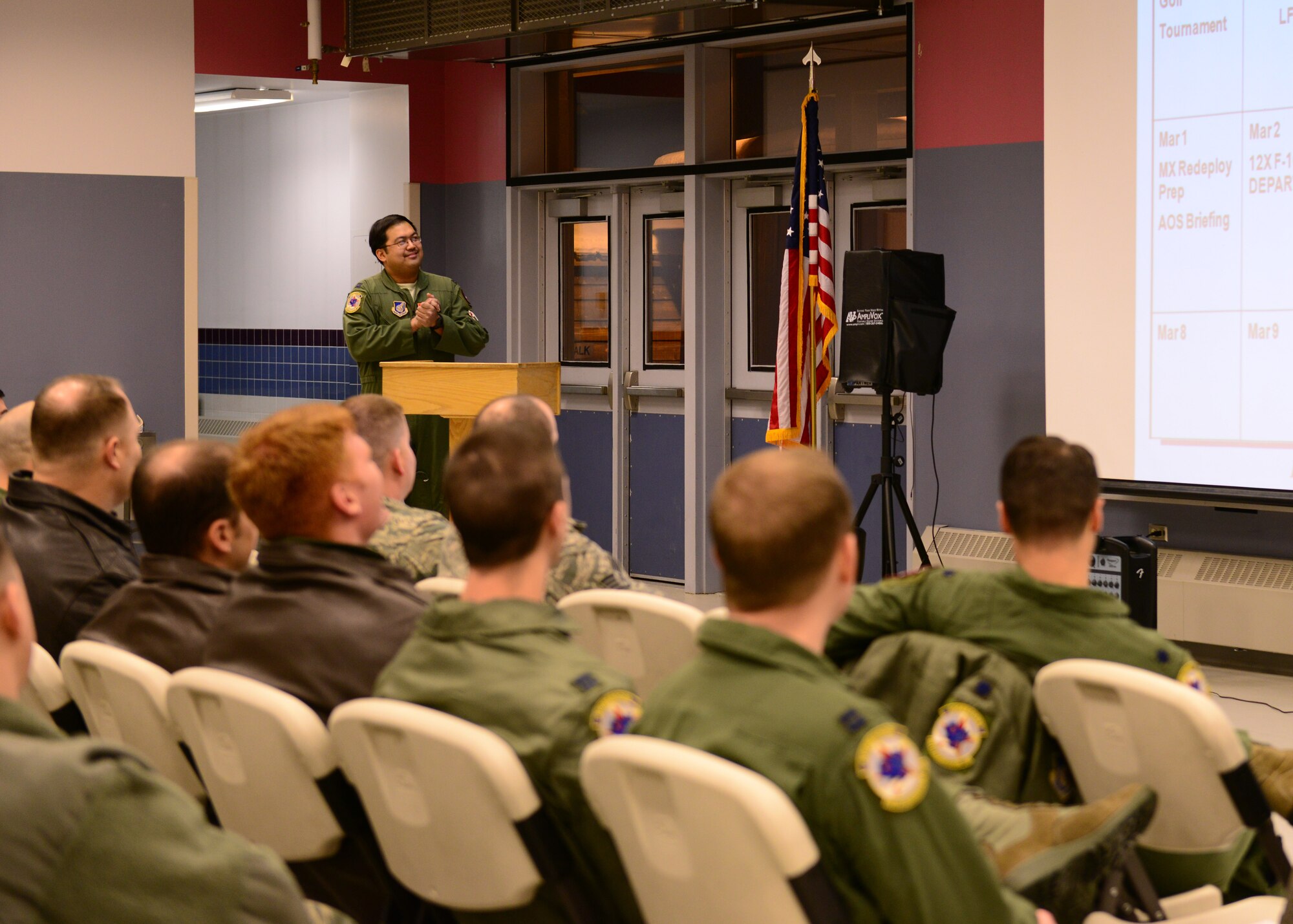U.S. Air Force Capt. Jaime Samson, an 18th Agressor Squadron air battle manager, gives a pre-deployment brief to more than 100 Airmen Jan. 13, 2015, at the Stevens Joint Mobility Complex at Eielson Air Force Base, Alaska. More than 150 Airmen from the 354th Fighter Wing will participate in the COPE NORTH exercise and are expected to perform more than 500 hours of flying. (U.S. Air Force photo by Senior Airman Ashley Nicole Taylor/Released)