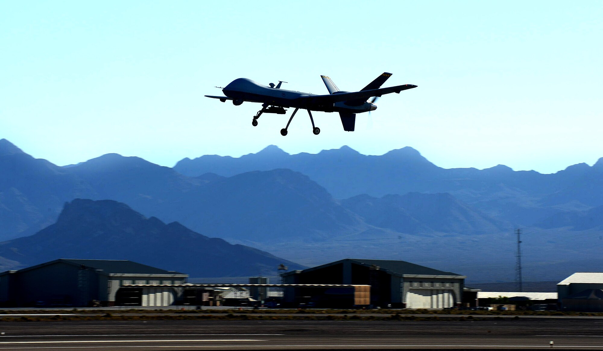 An MQ-9 Reaper performs touch-and-go flight patterns June 13, 2014, at Creech Air Force Base, Nevada. The MQ-9 Reaper is an armed, multi-mission, medium-altitude, long-endurance remotely piloted aircraft that is employed primarily as an intelligence-collection asset and secondarily against dynamic execution targets. (U.S. Air Force photo by Senior Master Sgt. Cecilio Ricardo/Released)