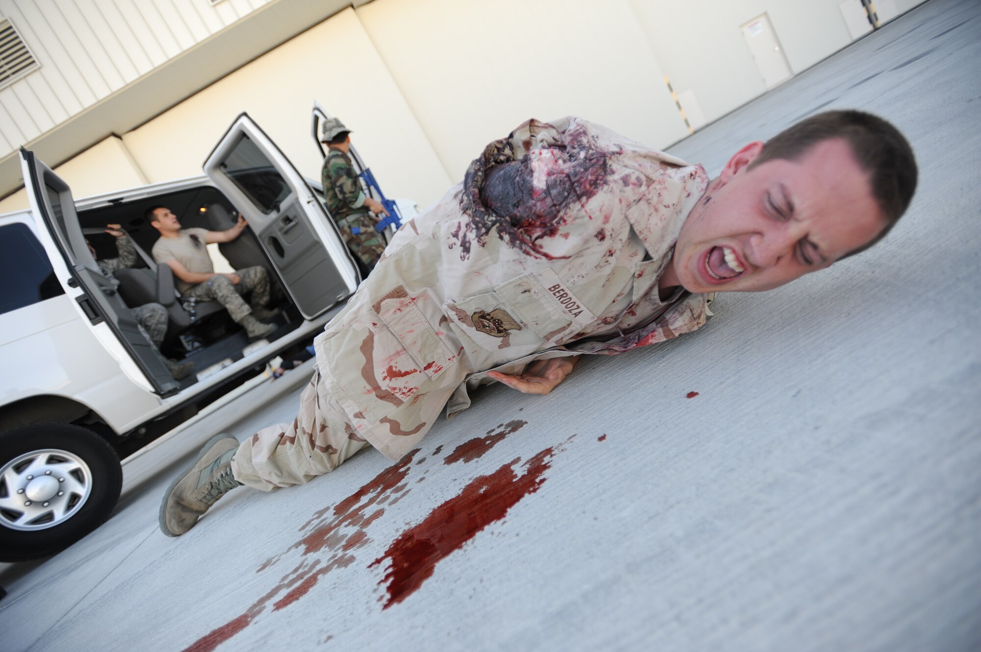 An Airman screams for help while wearing moulage to simulate losing an arm during an active shooter exercise at Creech Air Force Base, Nev., March 25, 2014. The exercise with Nellis Air Force Base, Nev., allowed first responders and medical personnel to receive realistic training. (U.S. Air Force photo by Staff Sgt. Nadine Barclay/Released)