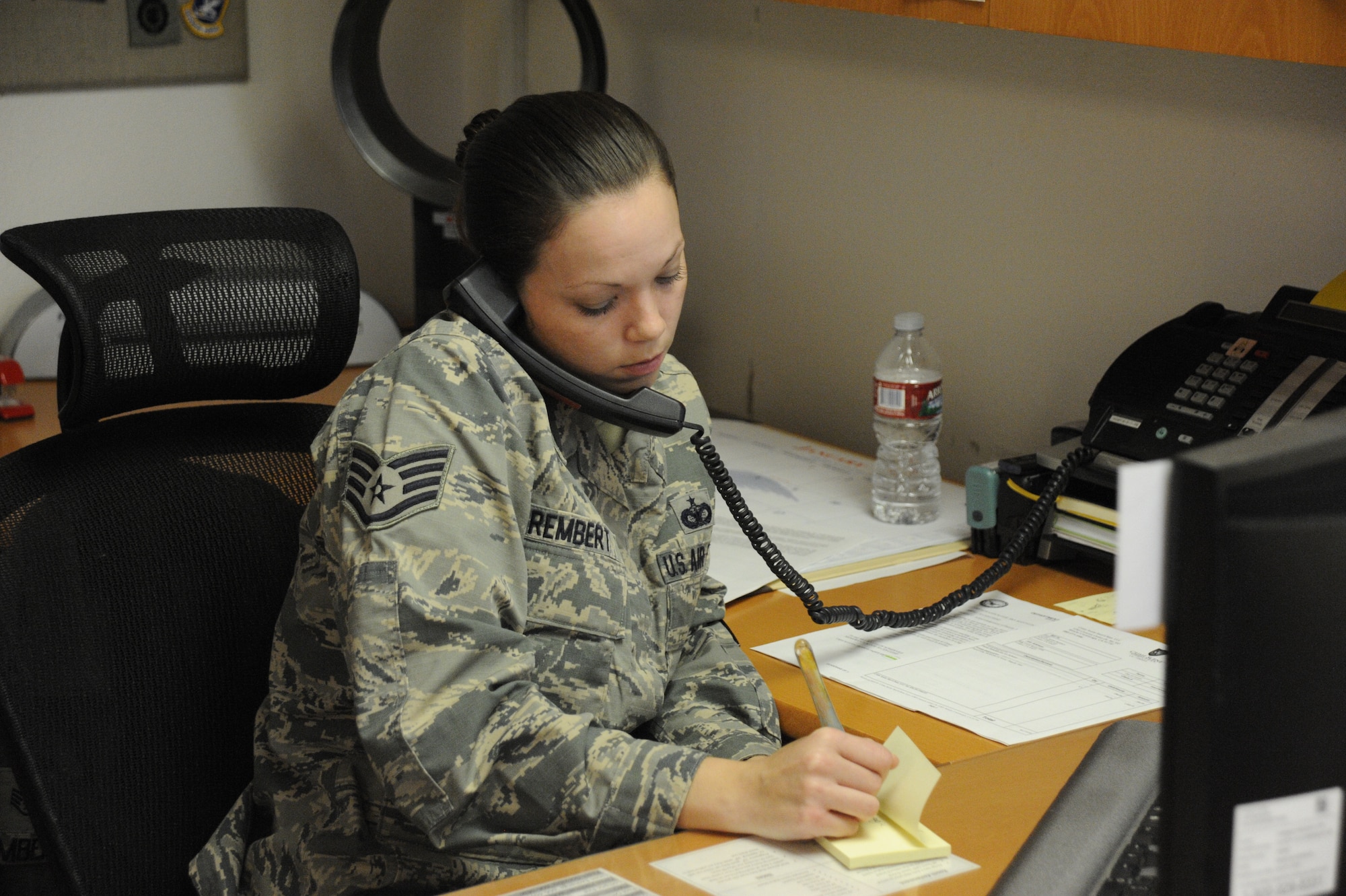 Staff Sgt. Amber Rembert, 30th Civil Engineer Squadron Airmen dormitory leader, speaks with a dorm Airman on the phone, Jan. 9, 2015, Vandenberg Air Force Base, Calif. Dorm management plays a pivotal role in the success of Airmen at Vandenberg. (U.S. Air Force photo by Airman Robert J. Volio/Released)