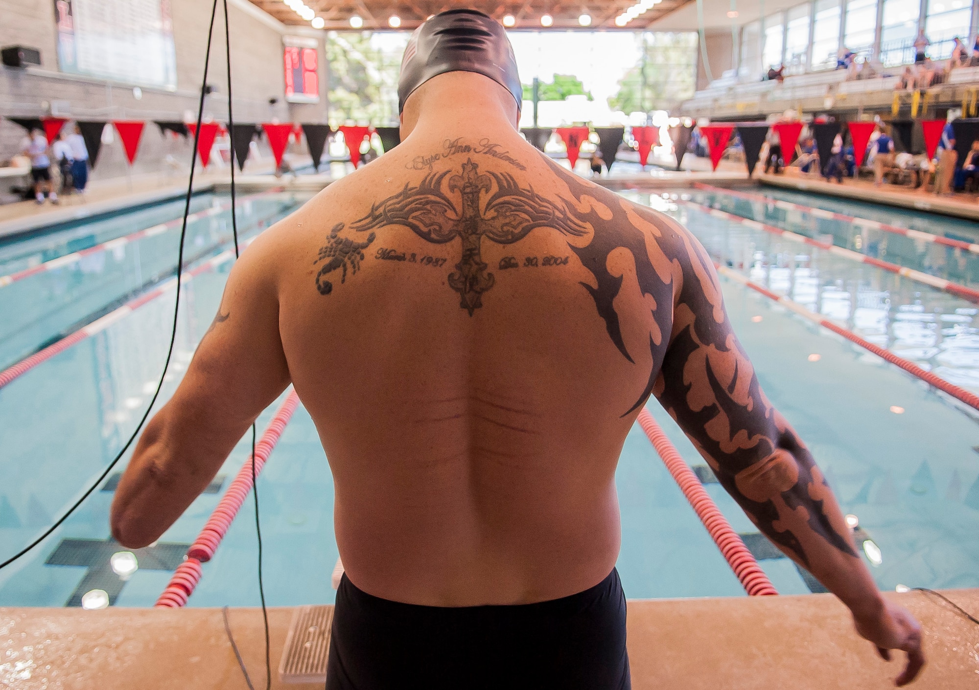 A wounded warrior participant prepares to enter the water for his swimming race at the 2014 Wounded Warrior Air Force Team Trials at Nellis Air Force Base, Nev., April 7, 2014. He and several wounded warriors competed in swimming, basketball, volleyball, track and filled events, cycling, archery and shooting competitions. (U.S. Air Force photo by Senior Master Sgt. Cecilio Ricardo)