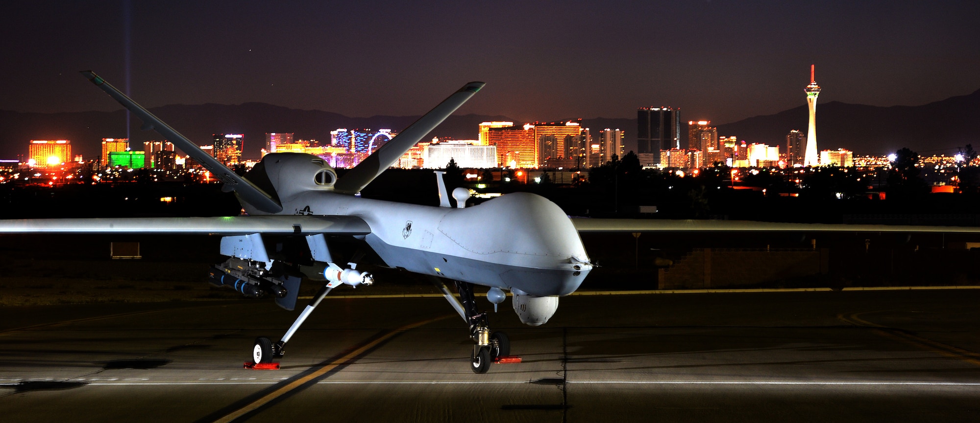 An MQ-9 Reaper is static displayed with the Las Vegas skyline during the Nellis Air Force Base 2014 Open House at Nellis AFB, Nevada, Nov. 8, 2014. The MQ-9 Reaper provides the United States Air Force with the intelligence, surveillance, and reconnaissance capabilities. (U.S. Air Force photo by Tech. Sgt. Nadine Barclay/Released)