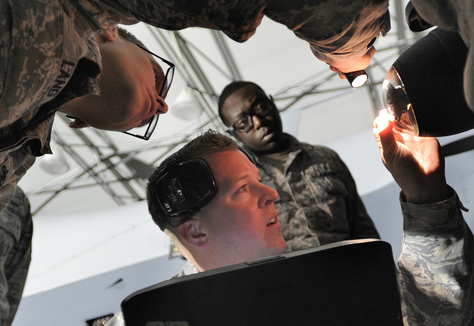 Airmen from the 432nd Aircraft Maintenance Squadron Tiger Aircraft Maintenance Unit weapons load crew inspect an AGM- 114 Hellfire missile loaded on an MQ-9 Reaper prior to launch at Creech Air Force Base, Nev., May 12, 2014. The 432nd Maintenance Group has continuously exceeded the RPA standard mission capable rate of 86 percent set by Air Combat Command through sound maintenance practices. Mission capable means the aircraft has no supply or maintenance issues preventing it from successfully completing a mission. (U.S. Air Force photo by Senior Master Sgt. Cecilio Ricardo/Released)