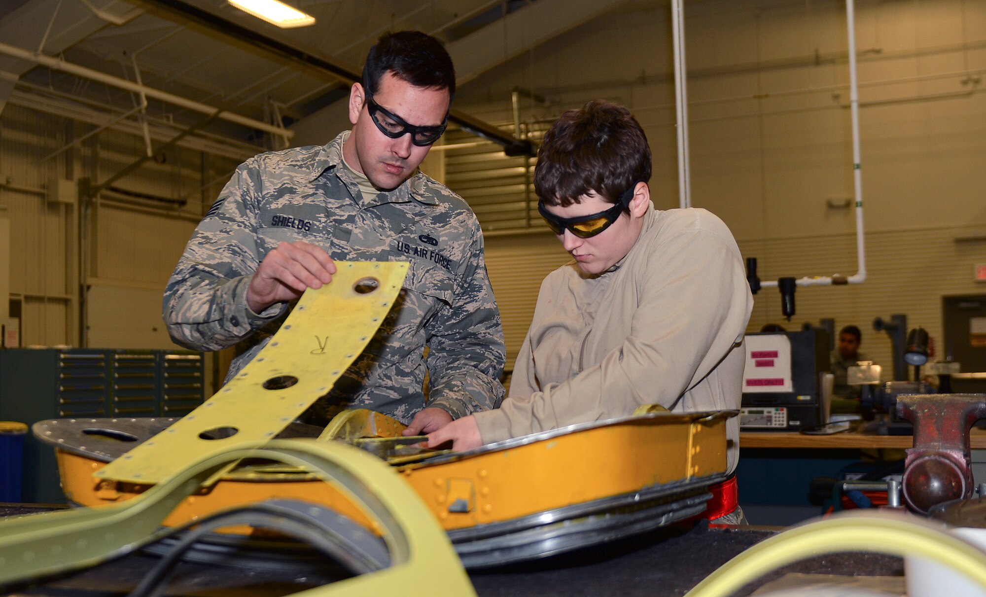 Staff Sgt. Andrew Shields, 22nd Maintenance Squadron aircraft structural maintenance craftsman and Airman 1st Class Shawnna Rawlands, 22nd MXS aircraft structural maintenance apprentice, inspect a KC-135R Stratotanker lower nose access door Dec. 4, 2014. After receiving maintenance each part must go through a final inspection before being sent to the corrosion shop to be primed. (U.S. Air Force photo/Senior Airman Colby L. Hardin)