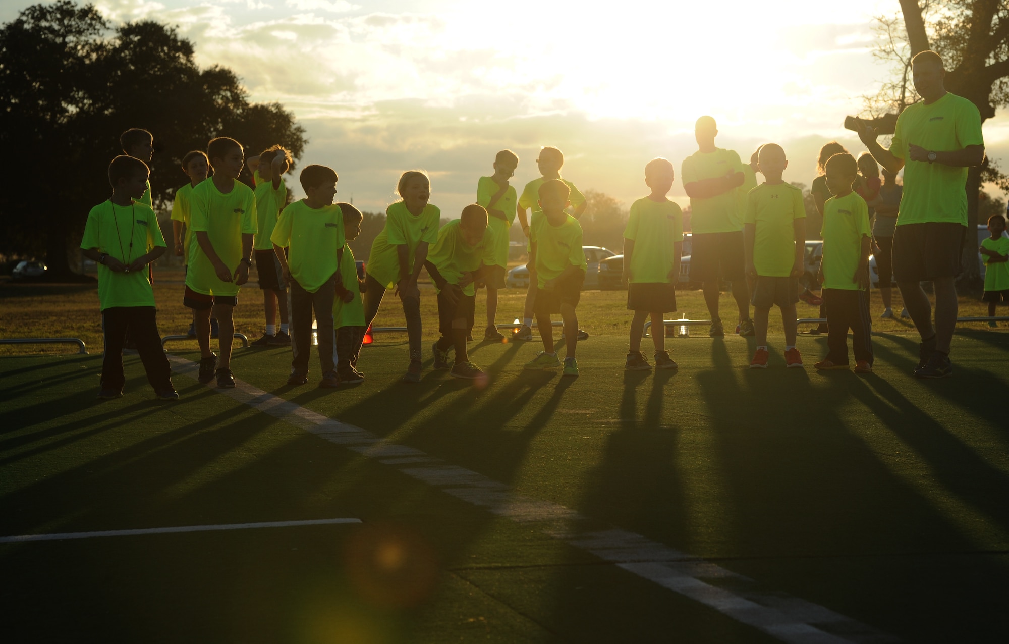 Keesler children participate in warm-up exercises during the Keesler Dragons Family Running Club practice Jan. 12, 2015, at the Triangle Track, Keesler Air Force Base, Miss.  More than 25 families participate in the running club. The club is free to anyone with access to base. The club has three running categories: Little Dragons- Ages 0-5; Medium Dragons- Ages 6-8; and Big Dragons- Ages 9 and up. The club meets on Mondays and Wednesdays at 4:30 p.m. (U.S. Air Force photo by Kemberly Groue)