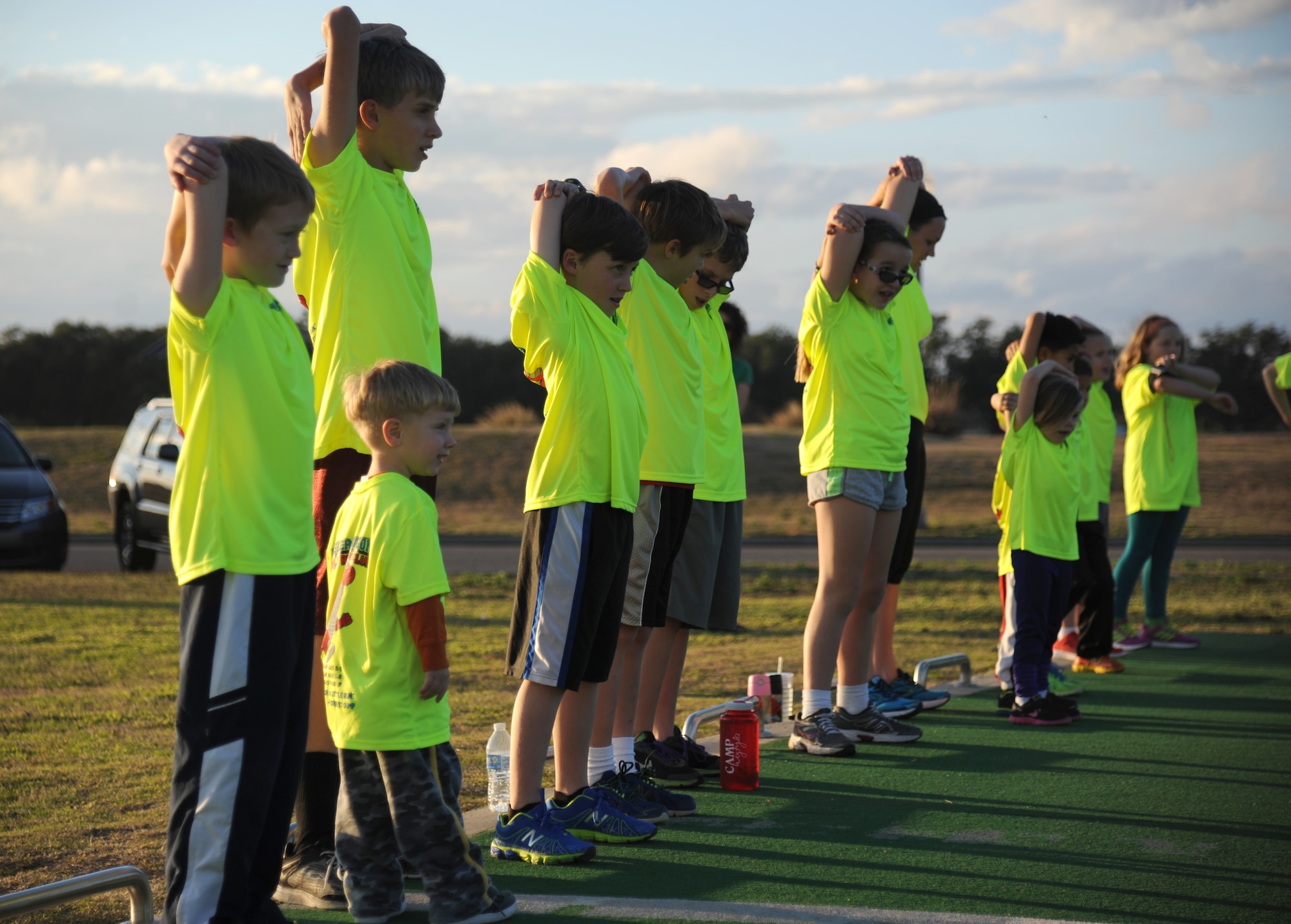 Keesler children participate in warm-up exercises during the Keesler Dragons Family Running Club practice Jan. 12, 2015, at the Triangle Track, Keesler Air Force Base, Miss.  More than 25 families participate in the running club. The club is free to anyone with access to base. The club has three running categories: Little Dragons- Ages 0-5; Medium Dragons- Ages 6-8; and Big Dragons- Ages 9 and up. The club meets on Mondays and Wednesdays at 4:30 p.m. (U.S. Air Force photo by Kemberly Groue)