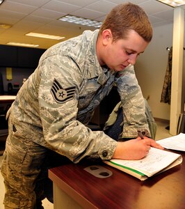 U.S. Air Force Staff Sgt. Konrad Kuzmin, 439th Supply Chain Operations Squadron weapons systems, stock and control technician, takes notes at Langley Air Force Base, Va., Jan. 13, 2015. Members of the 439th SCOS came to the 633rd Logistics Readiness Squadron to receive training on the flight service center, where various parts are received that are broken and need to be fixed off base. (U.S. Air Force photo by Airman 1st Class Breonna Veal/Released)