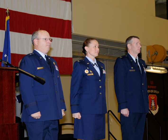 Brig. Gen. Dwight Balch, commander of the Air National Guard, left, Col. Bobbi Doorenbos, middle, and Col. Mark Anderson stand at attention Jan. 11, 2015, during the 188th Wing change of command ceremony held at Ebbing Air National Guard Base, Fort Smith, Ark. Doorenbos, who is the former commander of the 214th Reconnaissance Group, assumed command of the 188th Wing from Col. Mark Anderson. (U.S. Air National Guard photo by Staff Sgt. Hannah Dickerson/released)