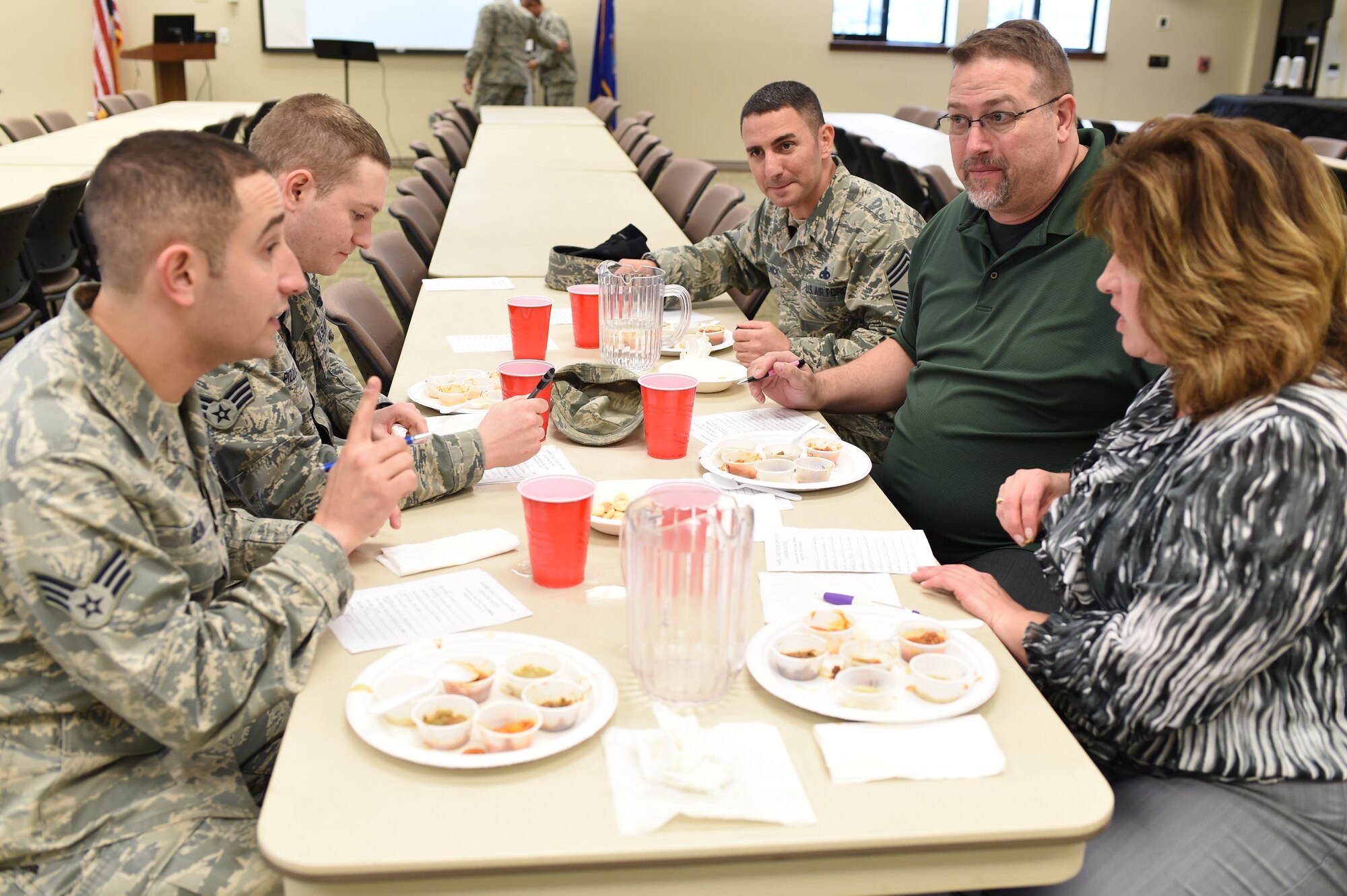 The official chili judge panel sits down and taste-tests each chili before the Buckley Chapel chili cook-off Jan. 7, 2015, on Buckley Air Force Base, Colo. Categories for judging included red, green, white, vegetarian, hot and overall chili, with each winner receiving a $20 gift card. (U.S. Air Force photo by Airman 1st Class Samantha Saulsbury/Released)
