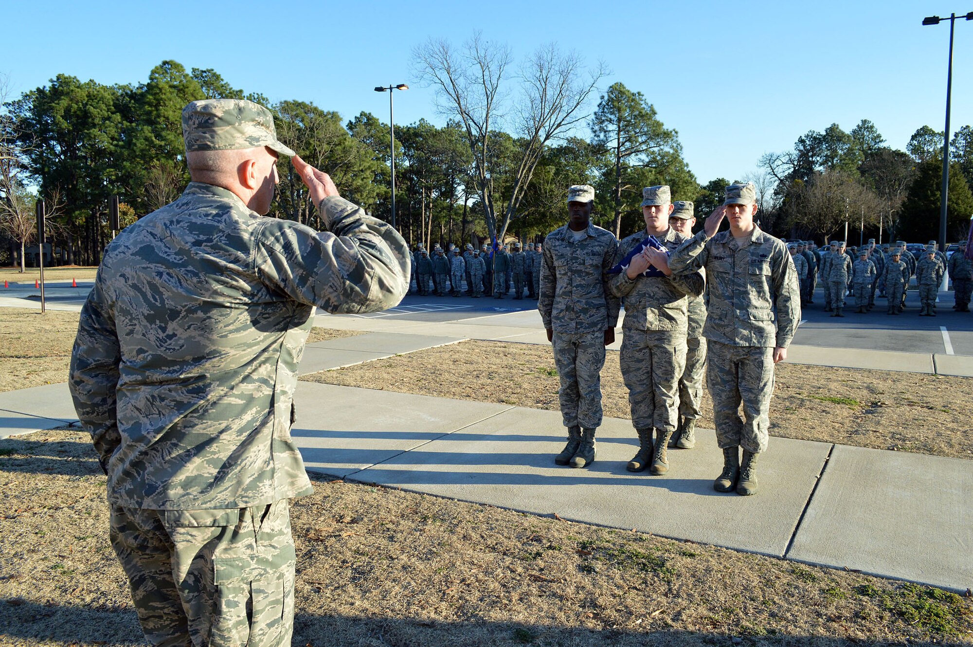 Air Force Staff Sgt. John Wildey, Pope Field Honor Guard Team, salutes and reports the colors are secured to Air Force Col. Kenneth Moss, 43rd Airlift Group commander, during the Group’s retreat ceremony held at the Pope Field flagstaff on Jan. 9, Pope Army Airfield, North Carolina. Retreat, the retirement of the colors from the day's activities, is a ceremony in which the unit honors the U.S. flag when it is lowered in the evening. (U.S. Air Force photo/Marvin Krause)