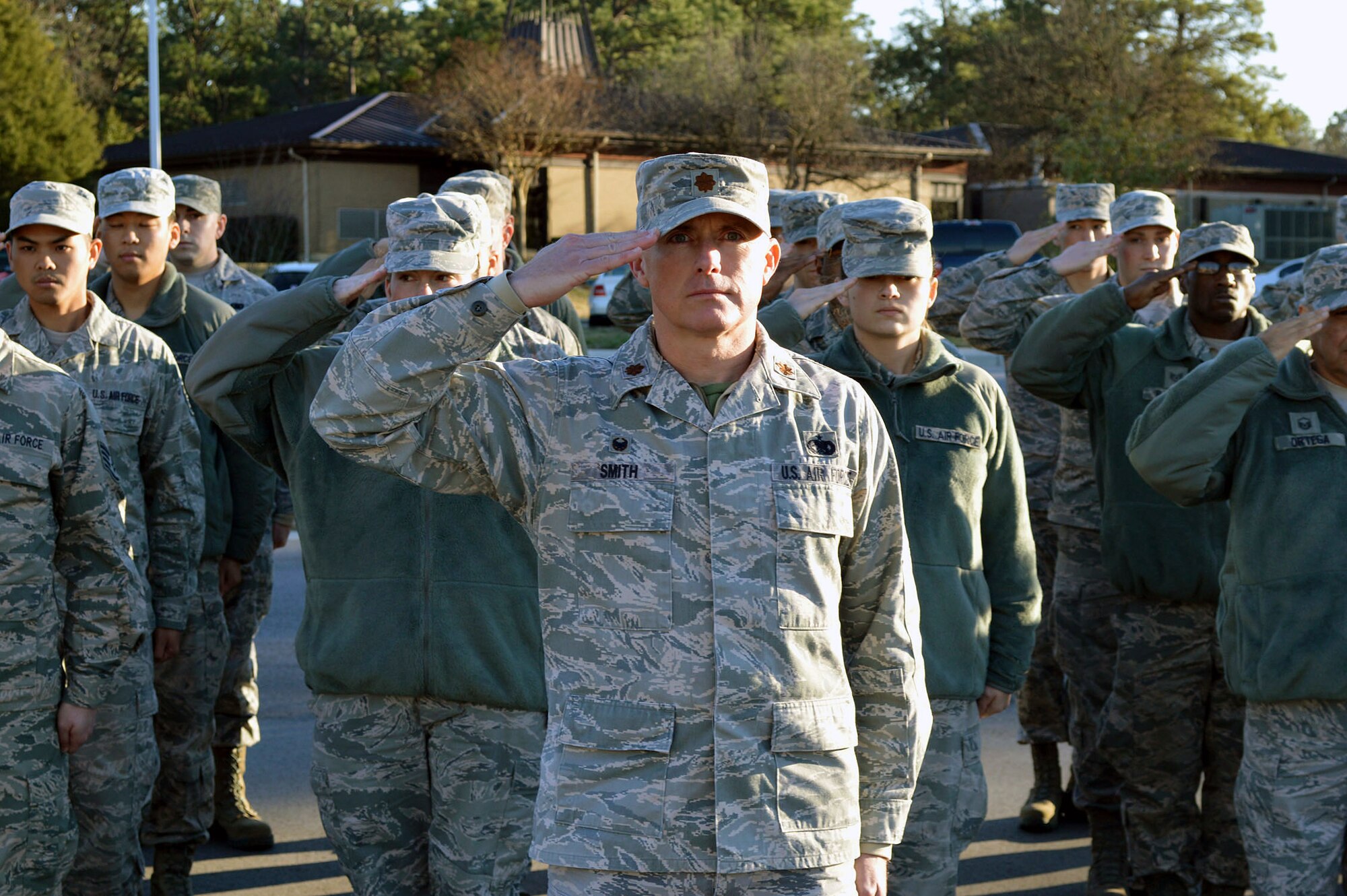 Air Force Maj. Peyton Smith, 43rd Logistics Readiness Squadron commander, salutes the U.S. flag with his squadron Airmen during a 43rd Airlift Group retreat ceremony held at the Pope Field flagstaff on Jan. 9, Pope Army Airfield, North Carolina. Retreat, the retirement of the colors from the day's activities, is a ceremony in which the unit honors the U.S. flag when it is lowered in the evening. (U.S. Air Force photo/Marvin Krause)