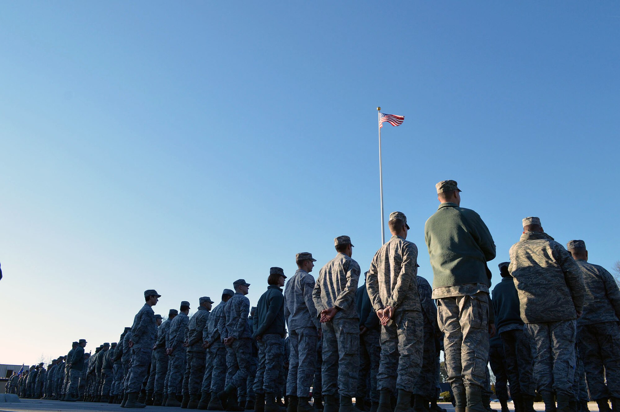 Over 300 Airmen from the 43rd Airlift Group participate in a retreat ceremony held at the Pope Field flagstaff on Jan. 9, Pope Army Airfield, North Carolina. Retreat, the retirement of the colors from the day's activities, is a ceremony in which the unit honors the U.S. flag when it is lowered in the evening. (U.S. Air Force photo/Marvin Krause)