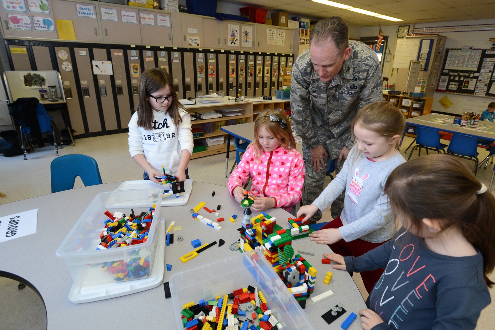 Col. Michael A. Vogel, 66th Air Base Group commander, watches first grade students create buildings during a tour of the Hanscom Primary School Jan. 9. Vogel met with students and staff during his visit of the school. The school is part of the Lincoln School District for students in kindergarten through third grade. (U.S. Air Force photo by Jerry Saslav)