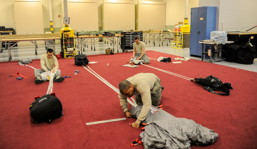 Aircrew flight equipment Airmen with the 38th Rescue Squadron pack ram-air canopies Jan. 12, 2015, at Moody Air Force Base, Ga. AFE Airmen inspect, maintain and pack parachutes for jumps. (U.S. Air Force photo by Senior Airman Sandra Marrero/Released)