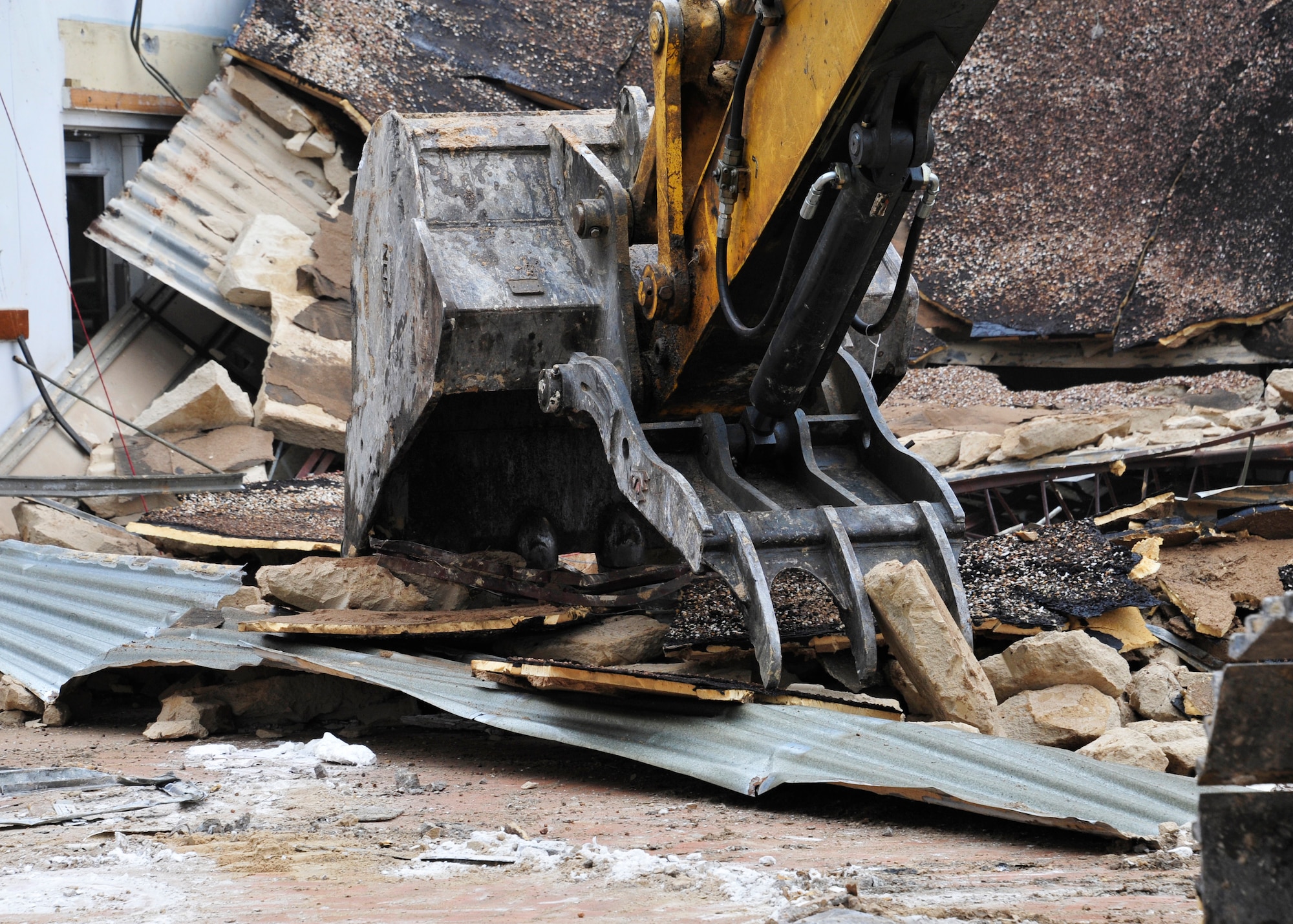 Personnel from the 96th Civil Engineer Group operate a demolition excavator to tear down Bldg. 606 in the former Federal Prison Camp compound at Eglin Air Force Base, Fla. on Jan. 12. The 24,529 square foot building was the dining facility for the inmates and guards and has been vacant since 2005. This building is considered excess, beyond economic repair and not usable. Demolition is estimated to be complete by the end of January. (U.S. Air Force photo/Ilka Cole)