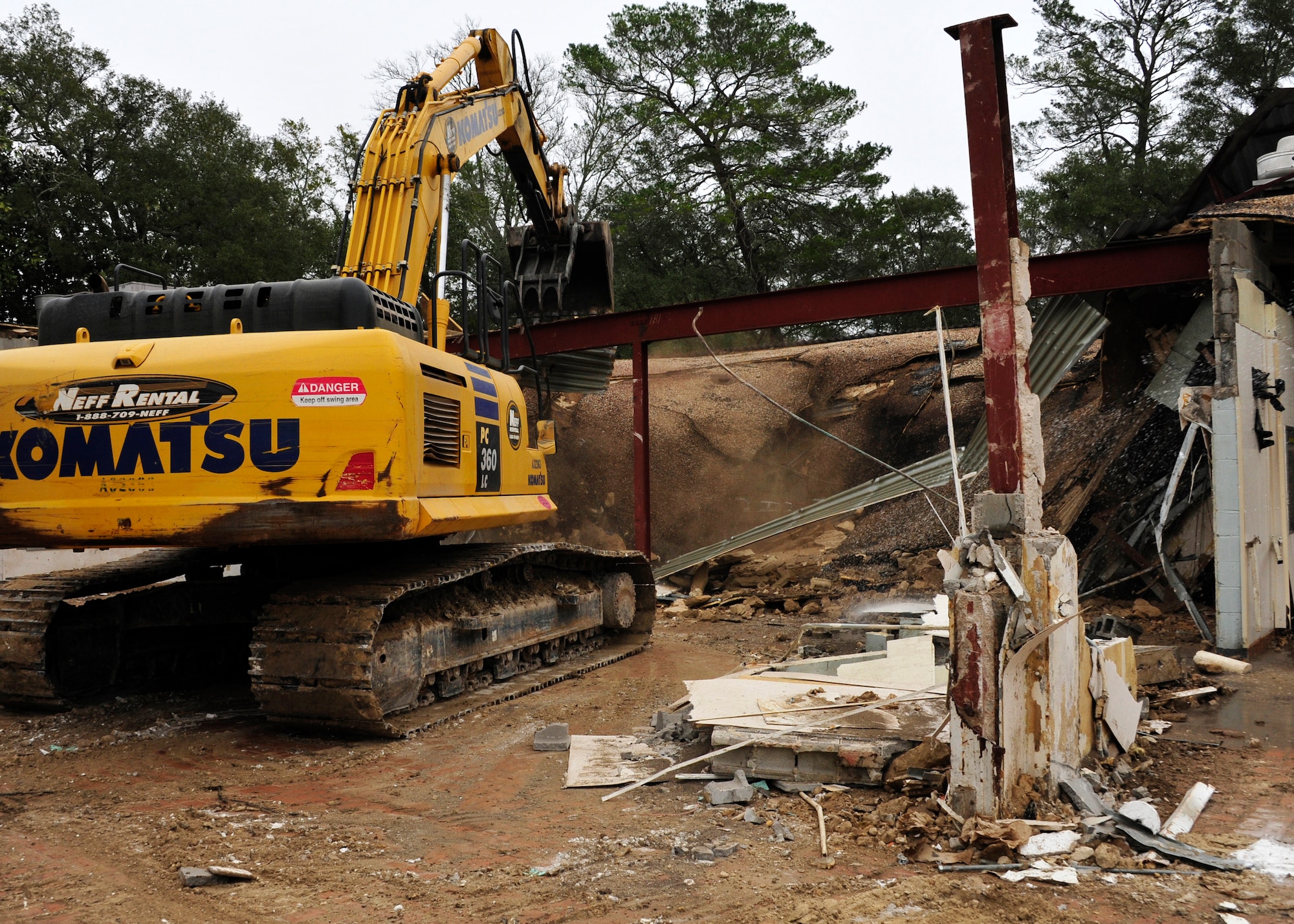 Personnel from the 96th Civil Engineer Group operate a demolition excavator to tear down Bldg. 606 in the former Federal Prison Camp compound at Eglin Air Force Base, Fla. on Jan. 12. The 24,529 square foot building was the dining facility for the inmates and guards and has been vacant since 2005. This building is considered excess, beyond economic repair and not usable. Demolition is estimated to be complete by the end of January. (U.S. Air Force photo/Ilka Cole)
