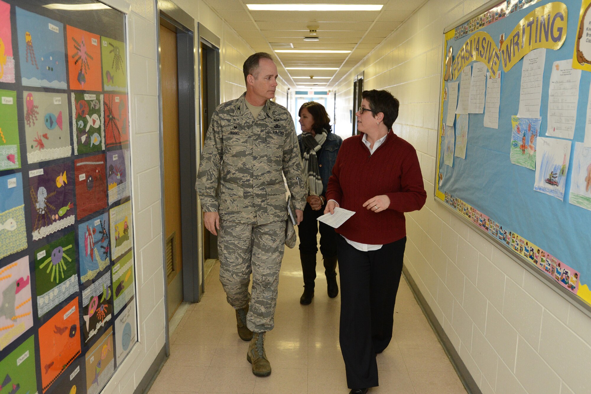 Col. Michael A. Vogel, 66th Air Base Group commander, walks with Beth Ludwig, Hanscom Primary School principal, and Laurel Wironen, school liaison specialist, during a tour of the primary school Jan. 9. In addition to his tour of the school, Vogel met with students and staff during his visit. The school is part of the Lincoln School District for students in kindergarten through third grade. (U.S. Air Force photo by Jerry Saslav)