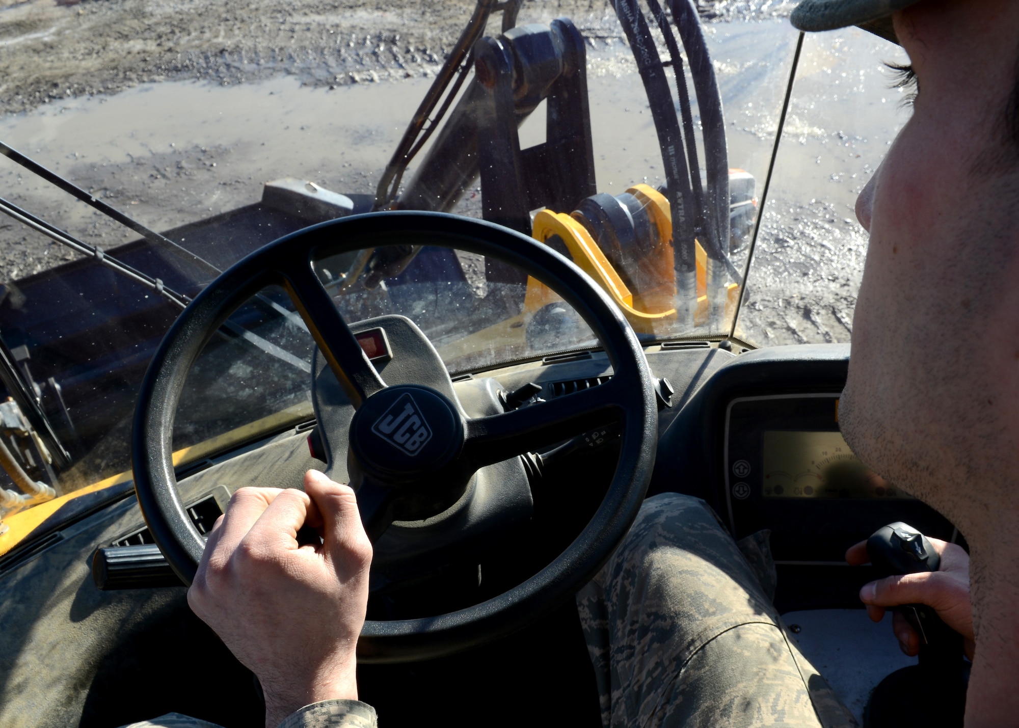 U.S. Air Force Airman 1st Class Brandon Ritenour, 633rd Civil Engineer Squadron heavy equipment operator, maneuvers a loader at Langley Air Force Base, Va., Jan. 9, 2015. Ritenour’s squadron designs, constructs, maintains and repairs hundreds of facilities and thousands of acres, to support approximately 151,000 active-duty military members, civilians and retirees, and $3.4 billion in mission assets. (U.S. Air Force photo by Airman 1st Class Devin Scott Michaels/Released)