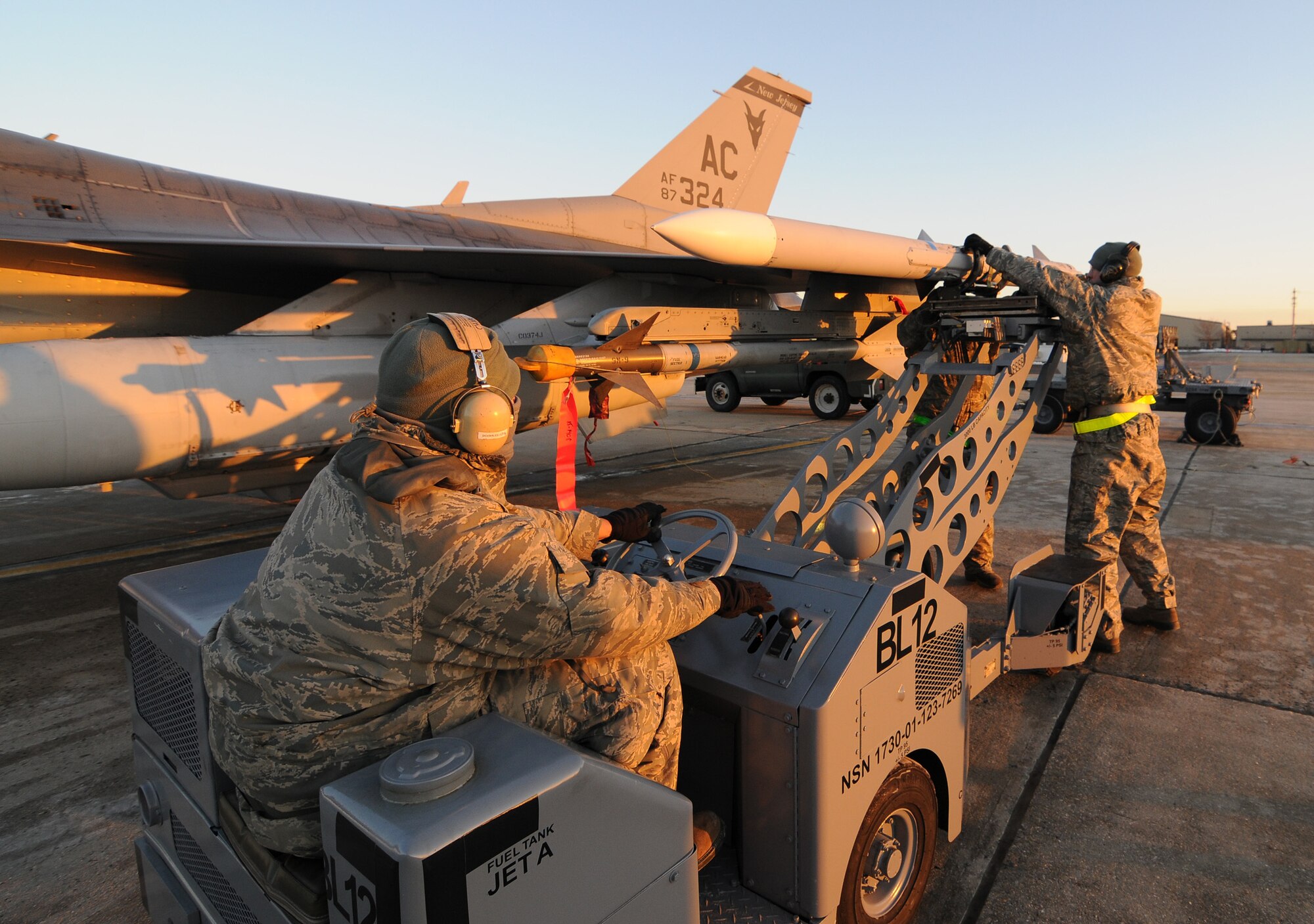 A picture of U.S. Air Force Airmen from the 177th Fighter Wing unloading munitions from an F-16C Fighting Falcon.