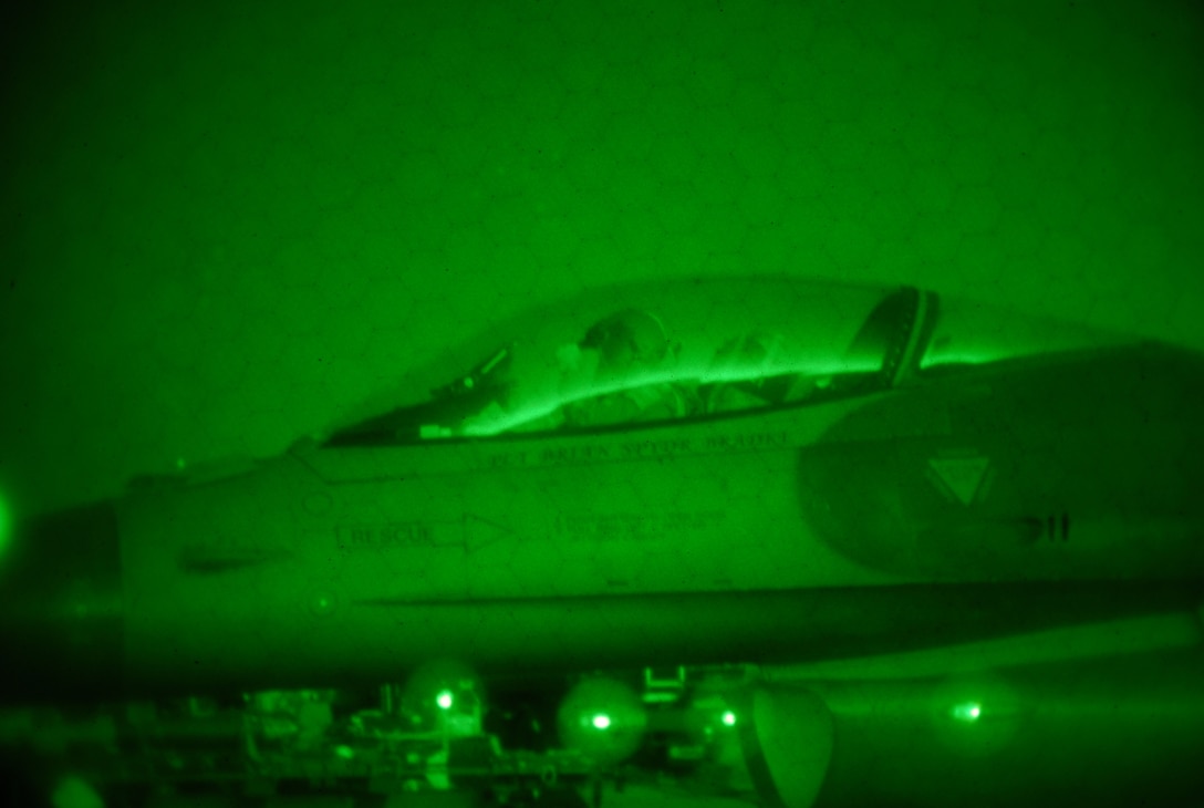 A U.S. Air Force F-16 pilot from the New Jersey Air National Guard's 177th Fighter Wing in Egg Harbor Township, N.J., prepares for takeoff on Jan. 9, 2015, as seen by a night vision lens. Pilots and maintainers worked through winter cold temperatures while participating in a training exercise that test the readiness of the wing. (U.S. Air Force photo by Airman 1st Class Amber Powell/Released)