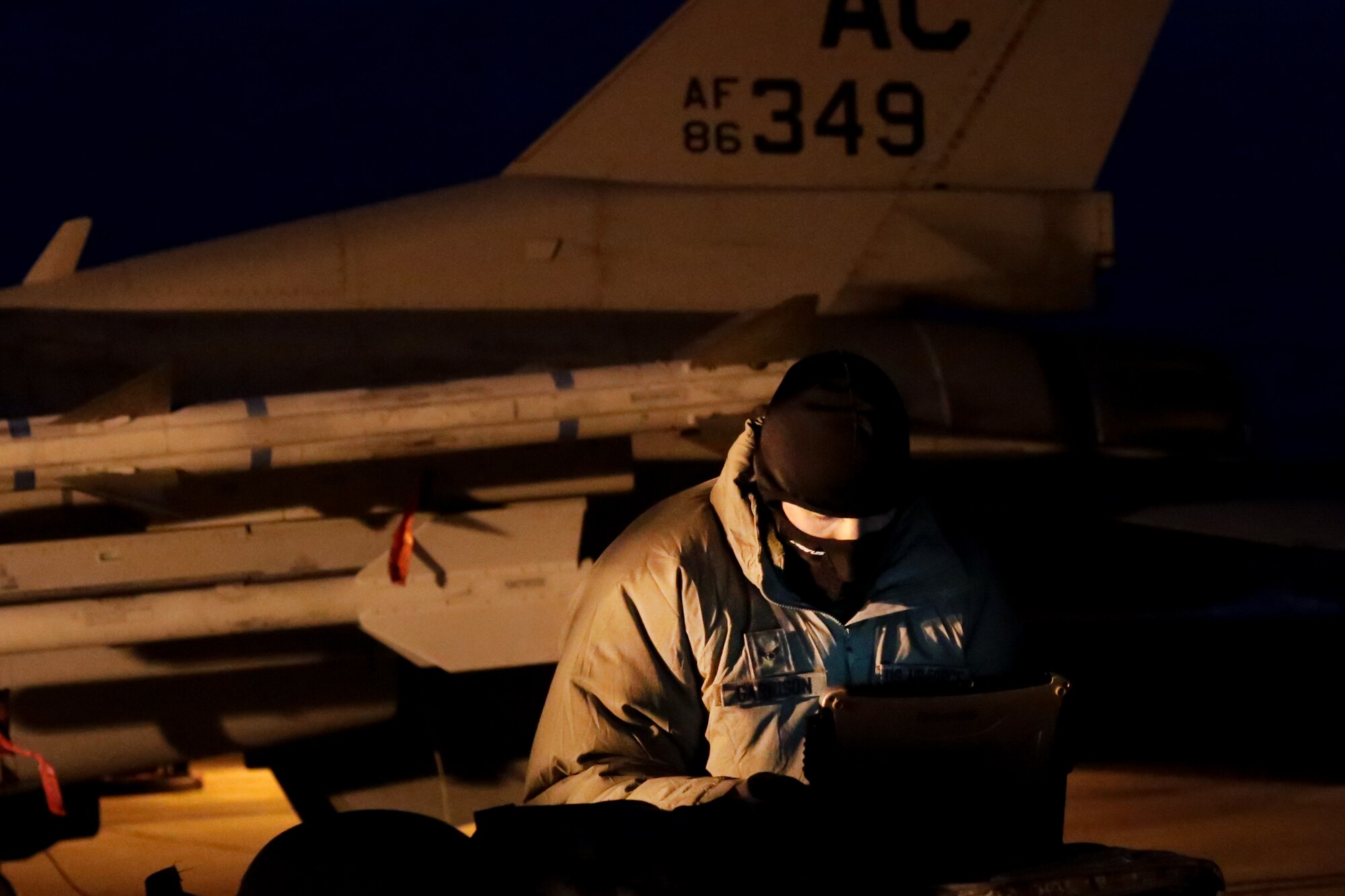 A picture of U.S. Air Force Airman 1st Class Christopher Garrison, 177th Aircraft Maintenance Squadron crew chief, going over technical orders.