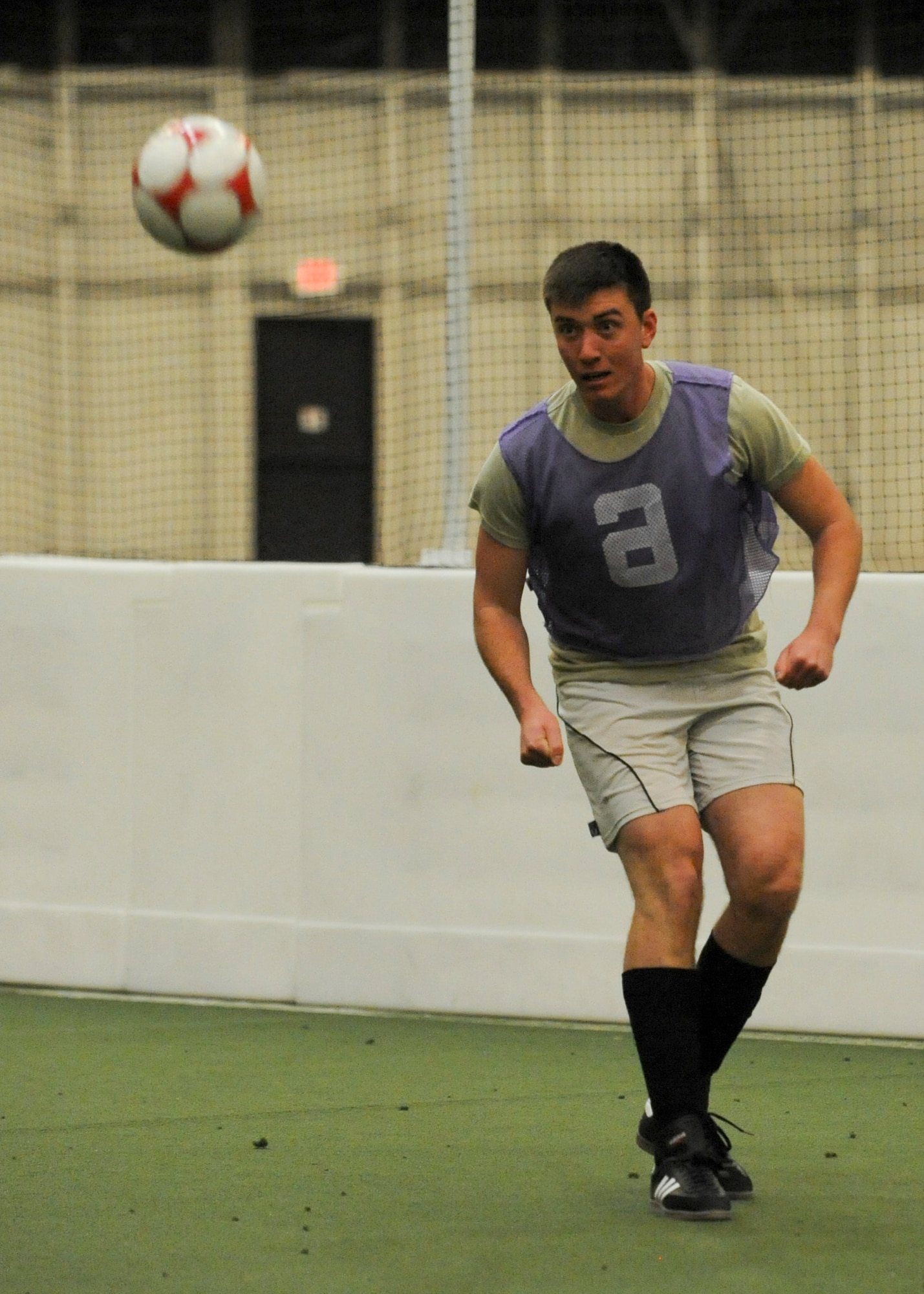 Senior Airman Kalvin Schultz, 28th Contracting Squadron contract specialist, participates in a soccer match inside the Pride Hangar at Ellsworth Air Force Base, S.D., Dec. 17, 2014. Ellsworth’s intramural soccer league plays in the Pride Hangar every Tuesday and Thursday night, until the final four teams have earned spots in the playoffs. (U.S. Air Force photo by Senior Airman Anania Tekurio/Released)