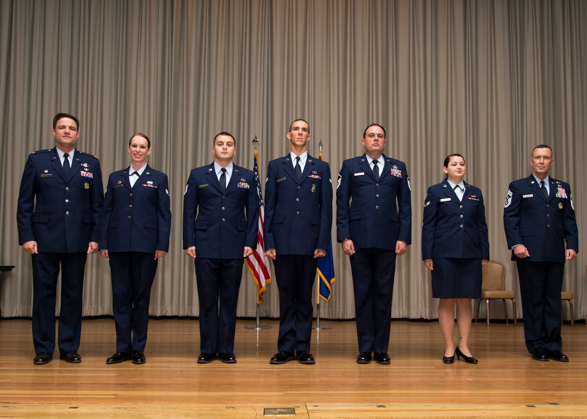 Col. Rodney Todaro, 412th Operations Group commander (far left), and Chief Master Sgt. David Smith, 412th Test Wing command chief (far right), officiated the monthly enlisted promotion ceremony Dec. 31 at the base theater. (U.S. Air Force photo by Christian Turner)