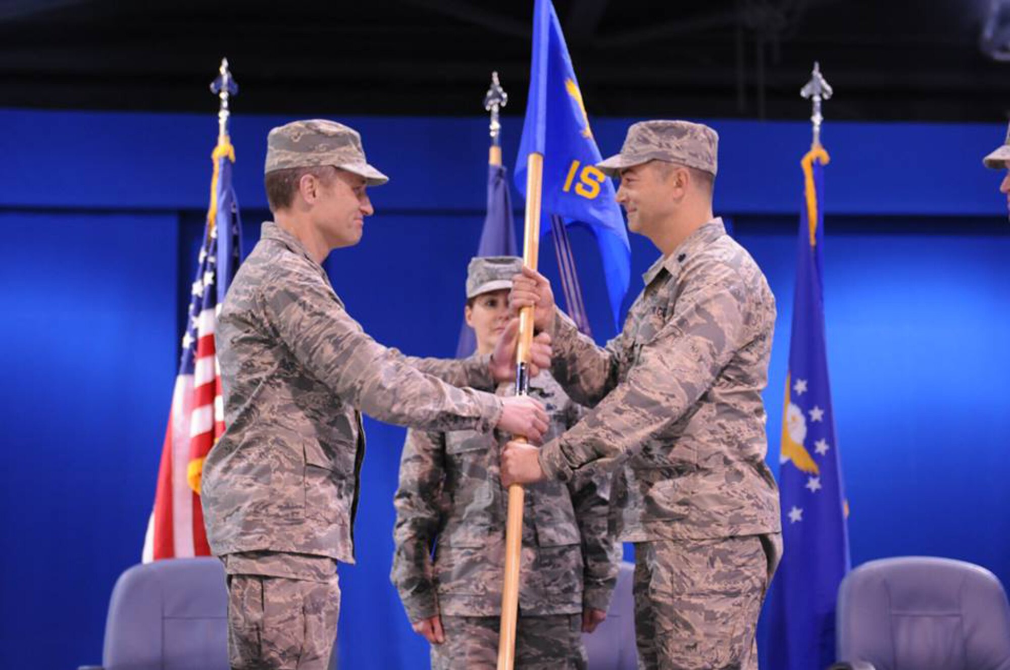 Lt. Col. Thomas McAtee, 192nd Operations Group Commander, presents the unit guidon for the 192nd Intelligence Squadron to Lt. Col. David R. Lands, signifying his assumption of command of the unit, during a change of command ceremony held Jan. 10 at Joint Base Langley-Eustis, Va. Lands assumed command from Lt. Col. Bryan E. Salmon who recently assumed a new role as the Air National Guard Advisor to the 480th Intelligence Surveillance Reconnaissance Wing. (U. S. Air Force photo by Tech. Sgt. Meghan Skrepenski, Virginia Air National Guard Public Affairs/RELEASED)