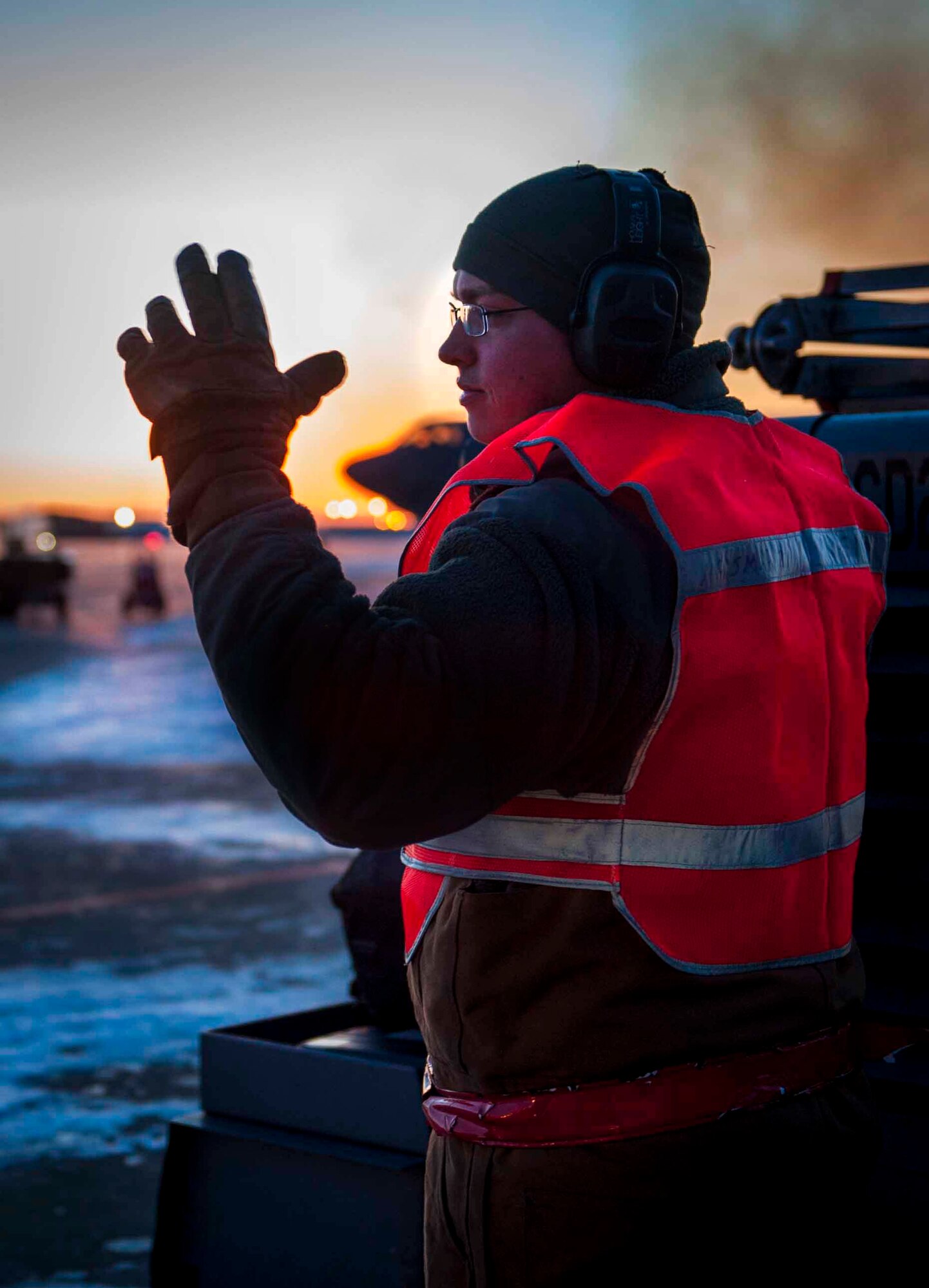 Senior Airman Taylor Lancaster, 5th Aircraft Maintenance Squadron aircraft crew chief, guides a truck to a trailer on Minot Air Force Base, N.D., Jan. 9, 2014. The truck was hitched to a trailer that holds all of the tools the Airmen need for the jet to transport to other jets as needed. (U.S. Air Force photo/Airman 1st Class Sahara L. Fales)