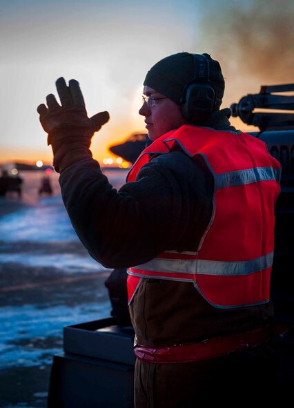 Senior Airman Taylor Lancaster, 5th Aircraft Maintenance Squadron aircraft crew chief, guides a truck to a trailer on Minot Air Force Base, N.D., Jan. 9, 2014. The truck was hitched to a trailer that holds all of the tools the Airmen need for the jet to transport to other jets as needed. (U.S. Air Force photo/Airman 1st Class Sahara L. Fales)