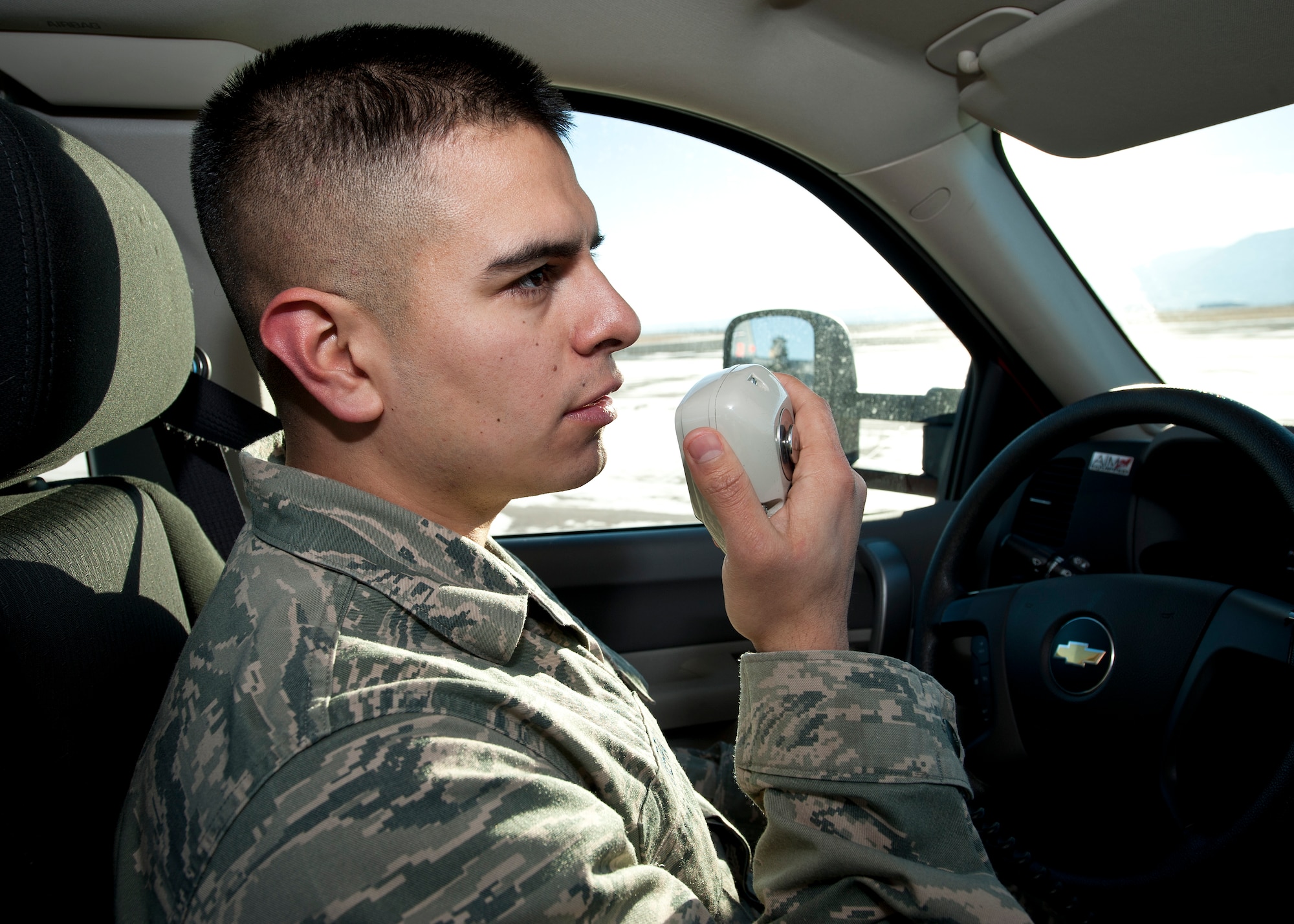 PETERSON AIR FORCE BASE, Colo. – Airman 1st Class Jesus Vera, 21st Operations Support Squadron airfield management shift lead, radios results to the office after completing a runway condition reading on the flightline Dec. 31, 2014. Airfield management is responsible for the safety of all incoming and outgoing aircraft and their crews, ranging from inspecting and maintaining the runways, taxiways and aprons of the airfield to responding to in-flight emergencies and coordinating with other base agencies to make aircrews’ stays as efficient as possible. (U.S. Air Force photo by Airman 1st Class Rose Gudex)