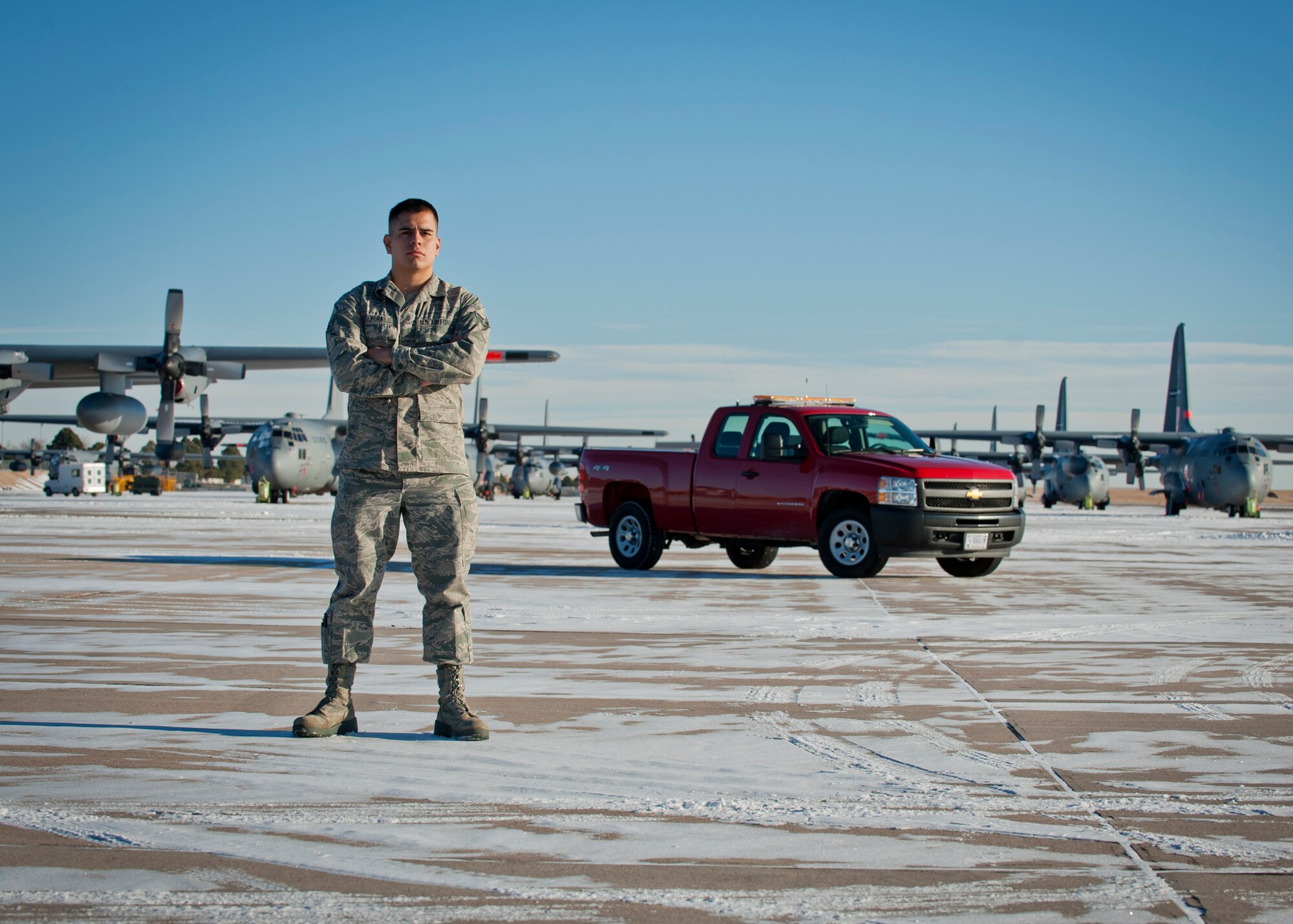 PETERSON AIR FORCE BASE, Colo. – Airman 1st Class Jesus Vera, 21st Operations Support Squadron airfield management shift lead, poses for a photo on the flightline Dec. 31, 2014. Airfield management is responsible for the safety of all incoming and outgoing aircraft and their crews, ranging from inspecting and maintaining the runways, taxiways and aprons of the airfield to responding to in-flight emergencies and coordinating with other base agencies to make aircrews’ stays as efficient as possible. (U.S. Air Force photo by Airman 1st Class Rose Gudex)