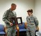 Chief Master Sgt. Michael Warner, Air Force Materiel Command command chief, presents Gen. Janet Wolfenbarger, AFMC commander, with the formal invitation to her Order of the Sword induction ceremony. Wolfenbarger was surprised with the notification of her induction on Sept. 3, 2014. This formal invitation was also a surprise, presented at the end of a brown-bag lunch session with the headquarters AFMC chief master sergeants. Wolfenbarger's induction ceremony is scheduled for Feb. 5, 2015, at the National Museum of the United States Air Force. (U.S. Air Force photo)