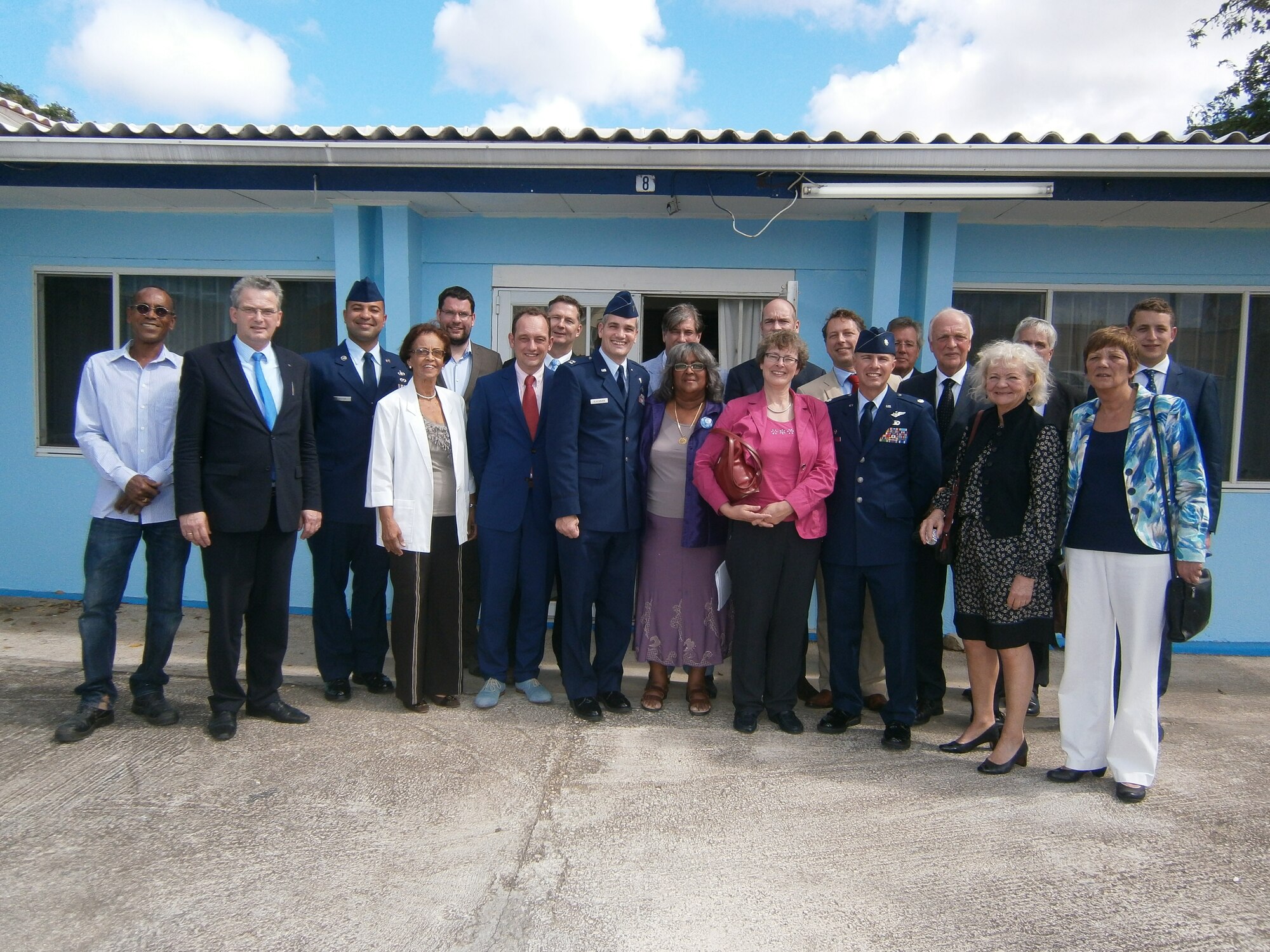 Members of the Dutch parliament, the U.S. Forward Operating Location and the U.S. Consulate General pose for a group photo in front of the Fundashon Sentro di Dama or SEDA building during a USFOL community relations program immersion visit, Jan. 5, 2015. The USFOL and the U.S. Consulate General hosted a delegation of 12 Dutch parliament members for the engagement, which included a visit to SEDA, a non-profit organization focused on supporting women, children and teens in crisis. The visit focused on the 14 year history of community projects completed by members of the USFOL and their longtime partner organization SEDA, highlighting project diversity ranging from painting facilities to donating school supplies. (Courtesy Photo)