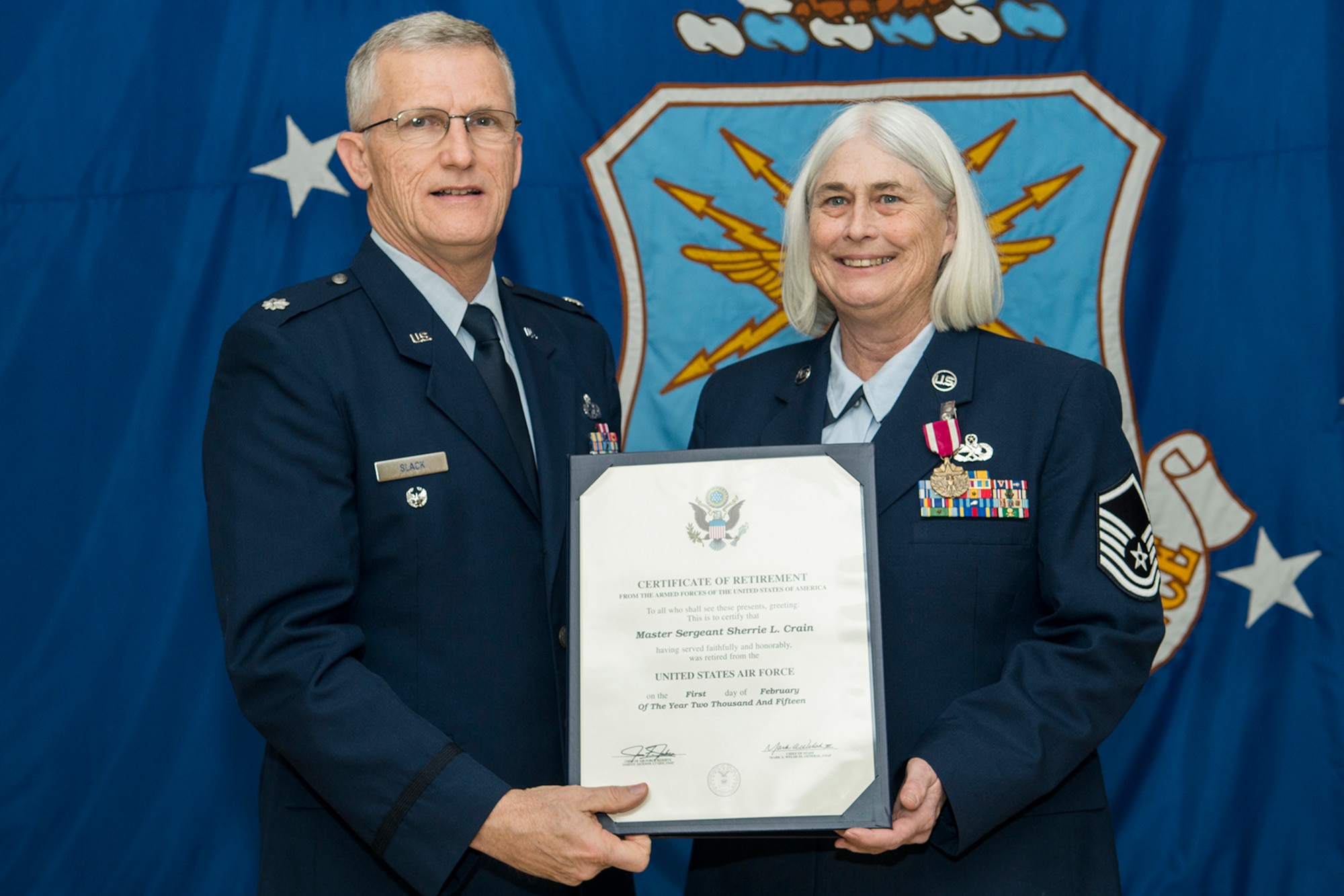 U.S. Air Force Master Sgt. Sherrie Crain is presented with a Certificate of Retirement during a ceremony on Jan. 10, 2015, Barksdale Air Force Base, La. Crain is the Career Advisor for the 307th Maintenance Group and is retiring from the Air Force Reserve after more than 30 years of service. (U.S.. Air Force photo by Master Sgt. Greg Steele/Released)