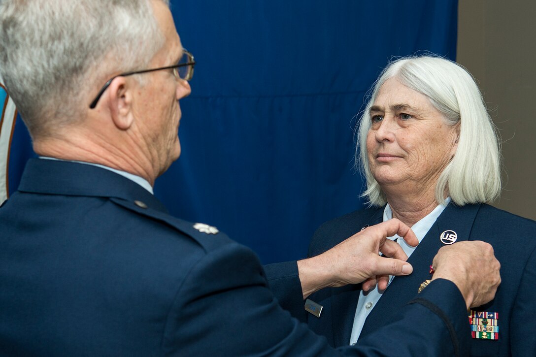 U.S. Air Force Master Sgt. Sherrie Crain is awarded the Air Force Meritorious Service Medal during her retirement ceremony, Jan. 10, 2015, Barksdale Air Force Base, La. Crain received the award for distinguished service as the Career Advisor for the 307th Maintenance Group. (U.S. Air Force photo by Master Sgt. Greg Steele/Released)