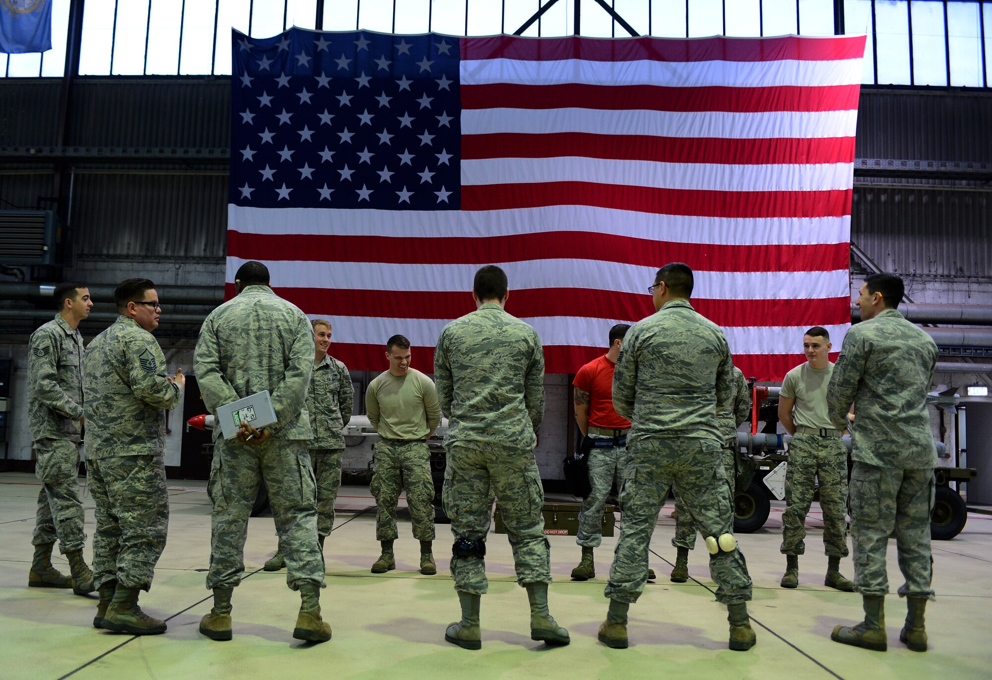 Airmen gather together before the start of the weapons load competition in Hangar 1 at Spangdahlem Air Base, Germany, Jan. 9, 2015. The loading teams were scored on their overall time and accuracy during the competition. (U.S. Air Force photo by Airman 1st Class Luke Kitterman/Released) 