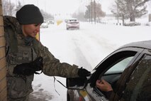 Senior Airman Kayla Sledge, 341st Security Forces Squadron member, checks military identification cards at Malmstrom Air Force Base’s main gate Jan. 6. During her 12-hour shift, Sledge and her team members are responsible for security checks, vehicle searches and ensuring only eligible military and civilian personnel are allowed on the instillation. (U.S. Air Force photo/Airman 1st Class Dillon Johnston) 