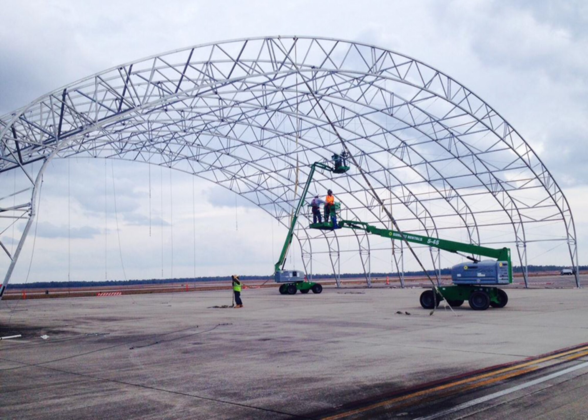 Cranes begin breaking down Duke Field's only sunshade to make way for a $33 million flightline construction project.  The project includes demolition of an old hangar, relocation of a wash rack and expansion of an aircraft parking area.  (Courtesy photo)