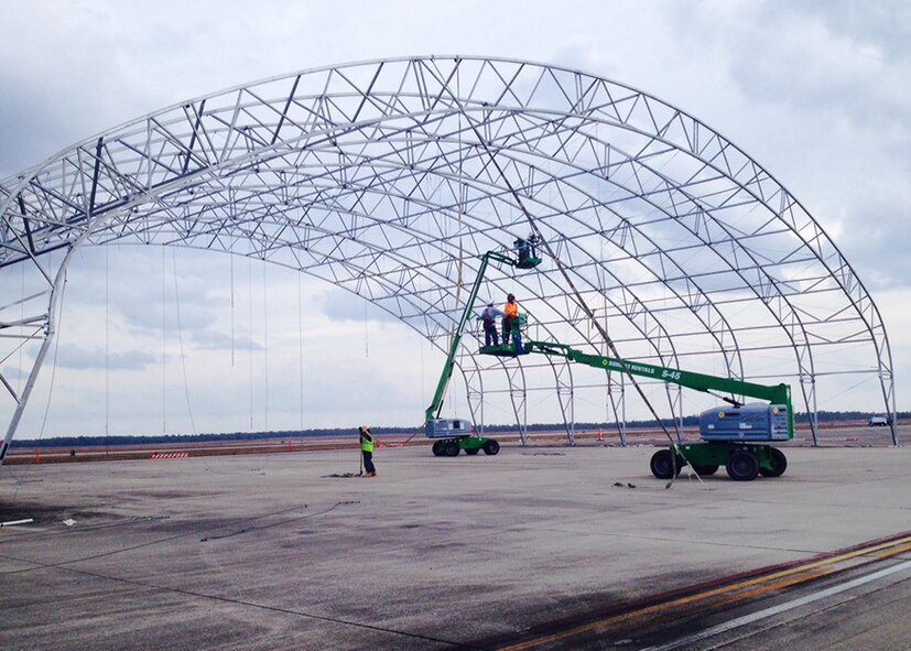 Cranes begin breaking down Duke Field's only sunshade to make way for a $33 million flightline construction project.  The project includes demolition of an old hangar, relocation of a wash rack and expansion of an aircraft parking area.  (Courtesy photo)