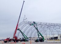 Cranes begin breaking down Duke Field's only sunshade to make way for a $33 million flightline construction project.  The project includes demolition of an old hangar, relocation of a wash rack and expansion of an aircraft parking area.  (Courtesy photo)