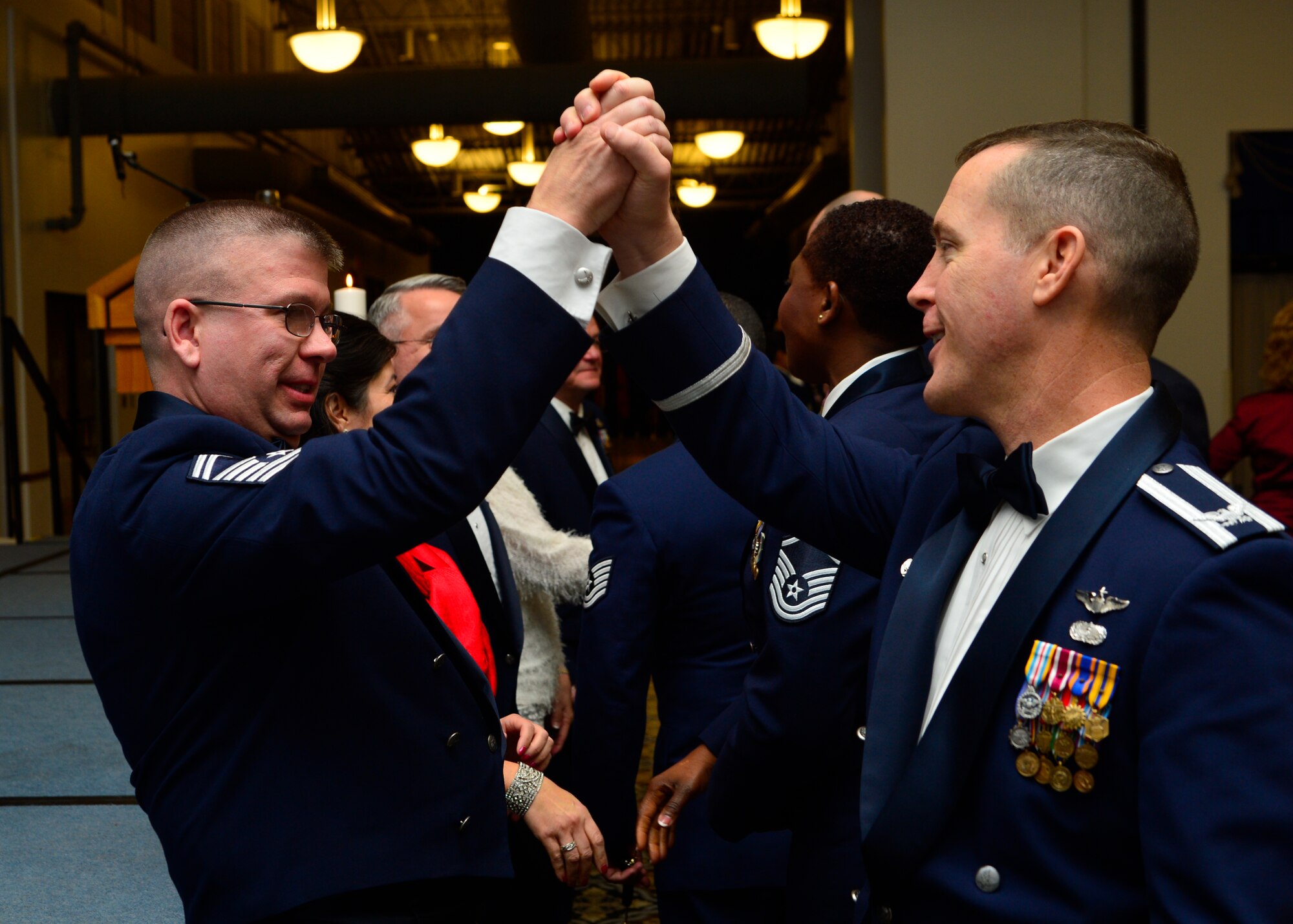 Col. Kevin Gordon, 436th Airlift Wing vice commander, congratulates Senior Master Sgt. John Tingle, 436th Civil Engineer Squadron superintendent, on his promotion to chief master sergeant following a recognition banquet Jan. 10, 2015, at the Landings Club on Dover Air Force Base, Del. As a chief master sergeant, Tingle will hold a rank that represents less than one percent of the total enlisted Air Force. (U.S. Air Force photo/Airman 1st Class William Johnson)