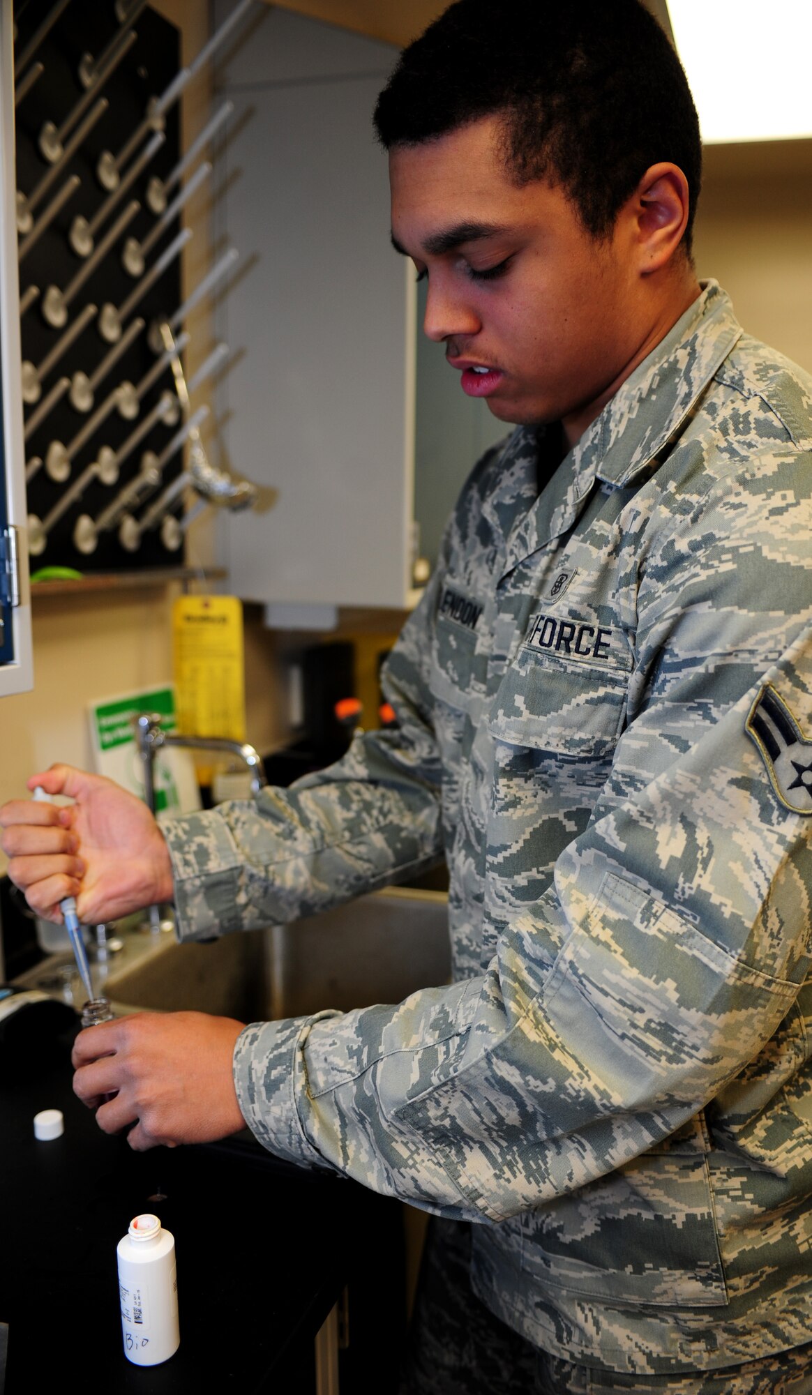 U.S. Air Force Airman 1st Class Alex McClendon, 633rd Aerospace Medicine Squadron bioenvironmental engineer technician, tests a water sample at Langley Air Force, Va., Jan. 9, 2015.  McClendon used phenol red to test the pH levels of the base water supply. In addition to testing pH levels, the 633rd AMDS test ten samples of water per month for bacteria. (U.S. Air Force photo by Airman 1st Class Areca T. Wilson/Released) 