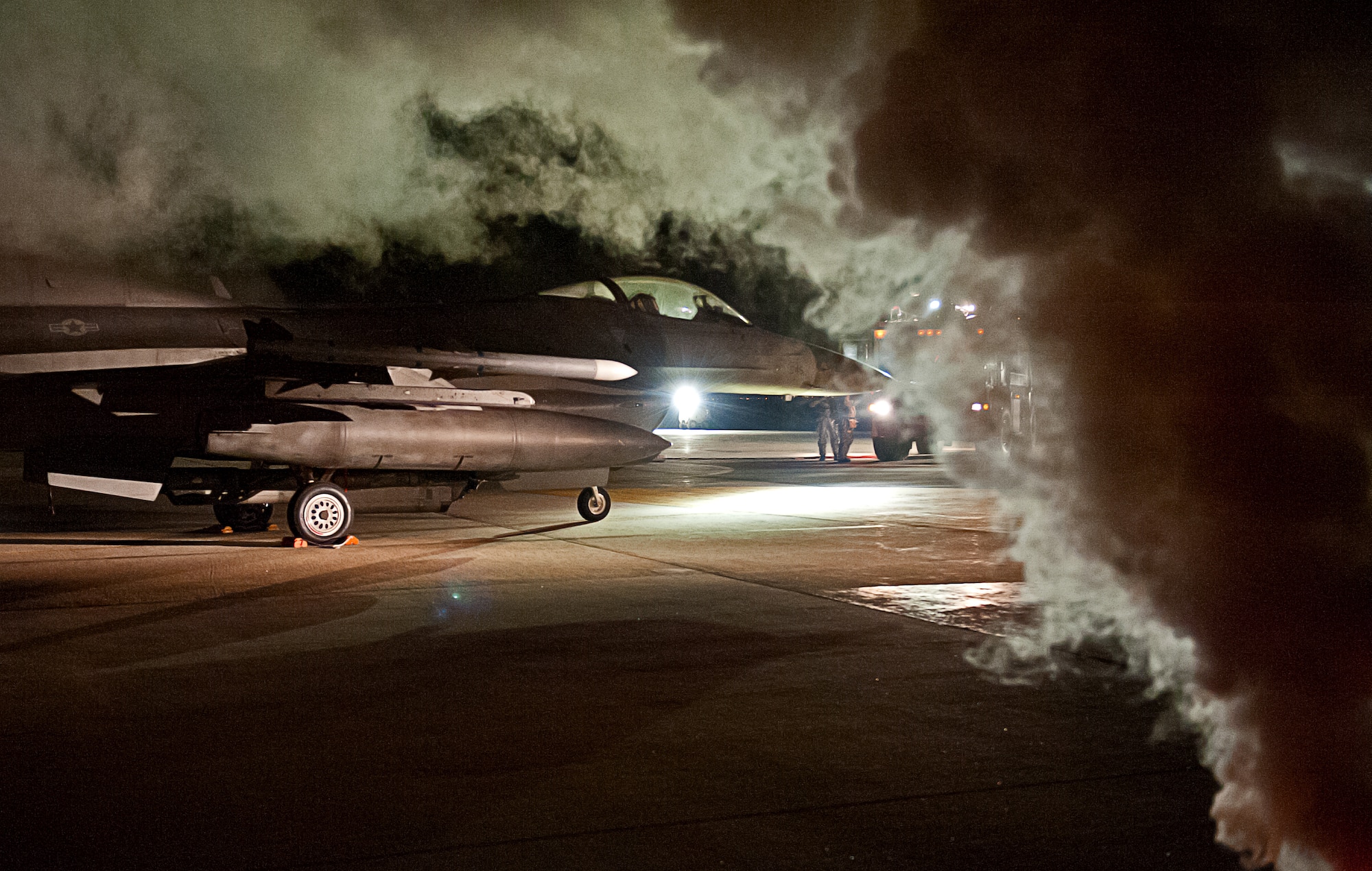 The 8th Civil Engineer Squadron fire department responds to a simulated aircraft accident during an emergency management exercise at Kunsan Air Base, Republic of Korea, Jan. 12, 2015. The EME tested the Wolf Pack’s ability to quickly respond to an incident on base while providing realistic training. (U.S. Air Force photo by Senior Airman Divine Cox/Released)