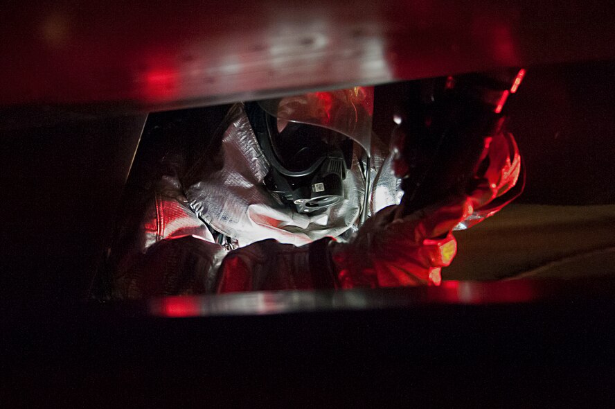 Staff Sgt. Cody Williams, 8th Civil Engineer Squadron lead firefighter, simulates hosing down an aircraft during an emergency management exercise at Kunsan Air Base, Republic of Korea, Jan. 12, 2015. The EME tested the Wolf Pack’s ability to quickly respond to an aircraft accident while providing realistic training. (U.S. Air Force photo by Senior Airman Divine Cox/Released)