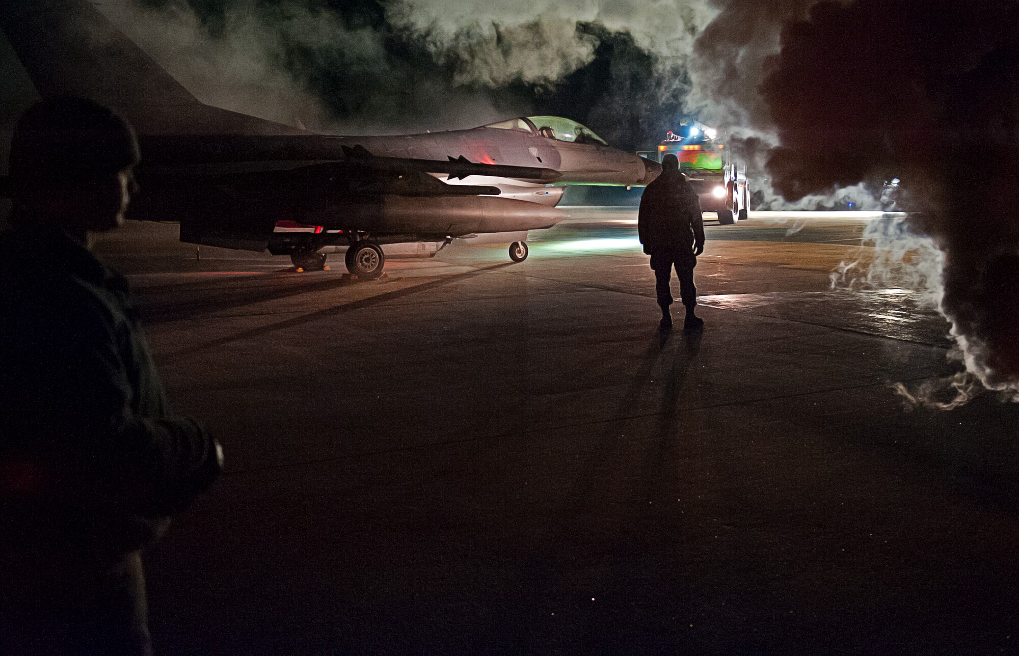 A member of the wing inspection team evaluates first responders during an emergency management exercise at Kunsan Air Base, Republic of Korea, Jan. 12, 2015. The EME tested Airmen ability to quickly respond to an aircraft accident on base while providing realistic training. (U.S. Air Force photo by Senior Airman Divine Cox/Released)