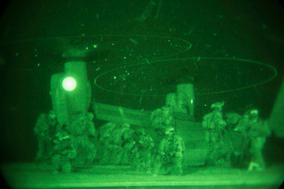 Marines provide security as others board an MV22B Osprey Jan. 10 on Camp Courtney in Okinawa, Japan. The Marines with the 31st Marine Expeditionary Unit’s Maritime Raid Force took part in a night raid as the first of three situational training events that make up the Realistic Urban Training Exercise. Expeditionary Operations Training Group, III Marine Expeditionary Force Headquarters Group, III MEF designed the training to test the MRF’s ability to respond to any contingency or crisis in the United States Pacific Command’s area of responsibility.