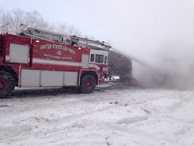 Michigan Air National Guard firefighters from the 110th Attack Wing, Battle Creek Air National Guard Base, respond to a multi-vehicle crash on the I-94 expressway near the base, Jan. 9, 2015.  