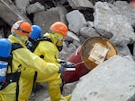 A member of the 103rd Civil Support Team (Weapons of Mass Destruction), left, decontaminates a local first responder after responding to a simulated chemical spill as part of the training scenario of exercise Vigilant Guard in Anchorage, Alaska, Monday, April 26, 2010. Vigilant Guard is an annual, disaster-based training scenario that tests the coordination of National Guard units with local, state, regional, and national disaster preparedness organizations.